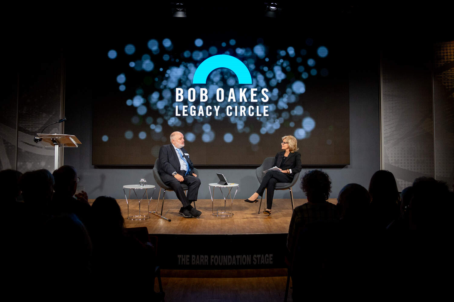 Robin Young speaks with former Morning Edition host Bob Oakes at the inaugural Bob Oakes Legacy Circle event. (Liz Linder for WBUR)