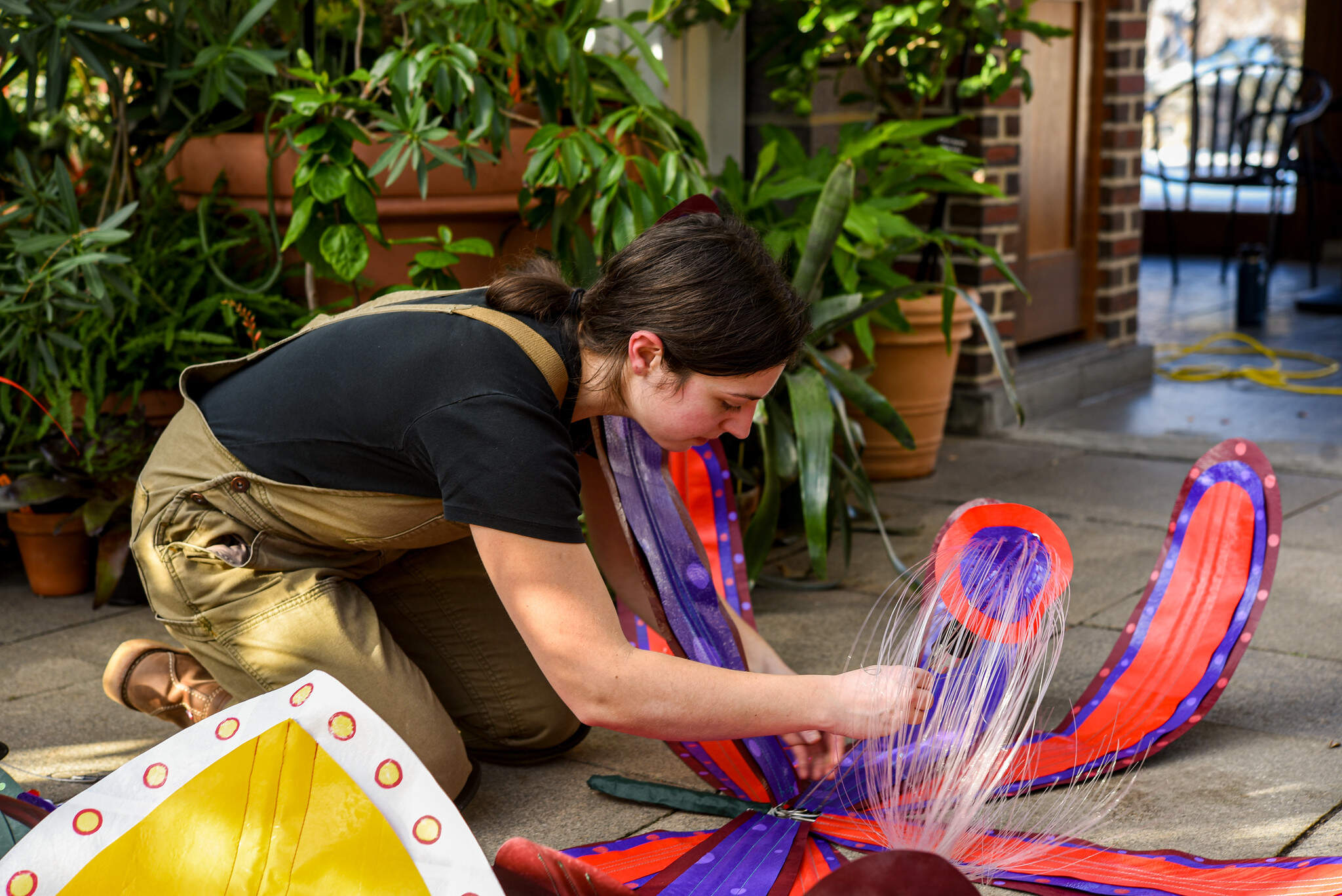 Artist Molly Gambardella works on one of her orchid sculptures as part of the "Patterns in Bloom" installation at the New England Botanic Garden (Courtesy/New England Botanic Garden)
