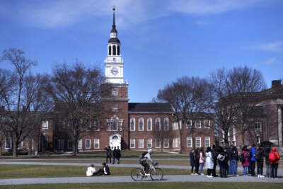 A college tour group pauses outside Baker Library at Dartmouth College, April 7, 2023, in Hanover, N.H. (Charles Krupa/AP)