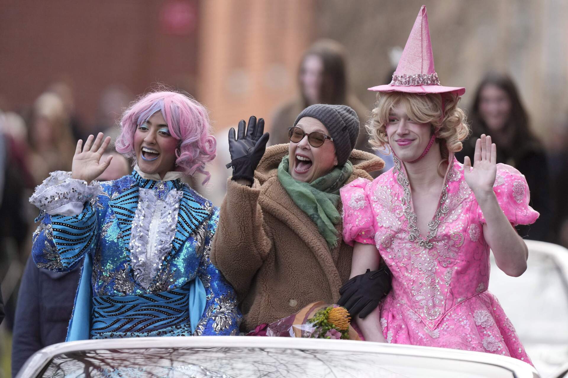 Actor Annette Bening, center, Hasty Pudding 2024 Woman of the Year, rides in a convertible through Harvard Yard. (Steven Senne/AP)