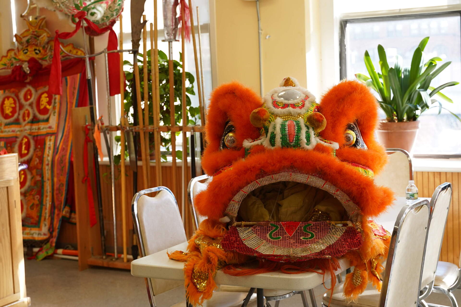 The head of a lion costume is sits on a desk ahead of a rehearsal for the parade. (Cici Yu/WBUR)