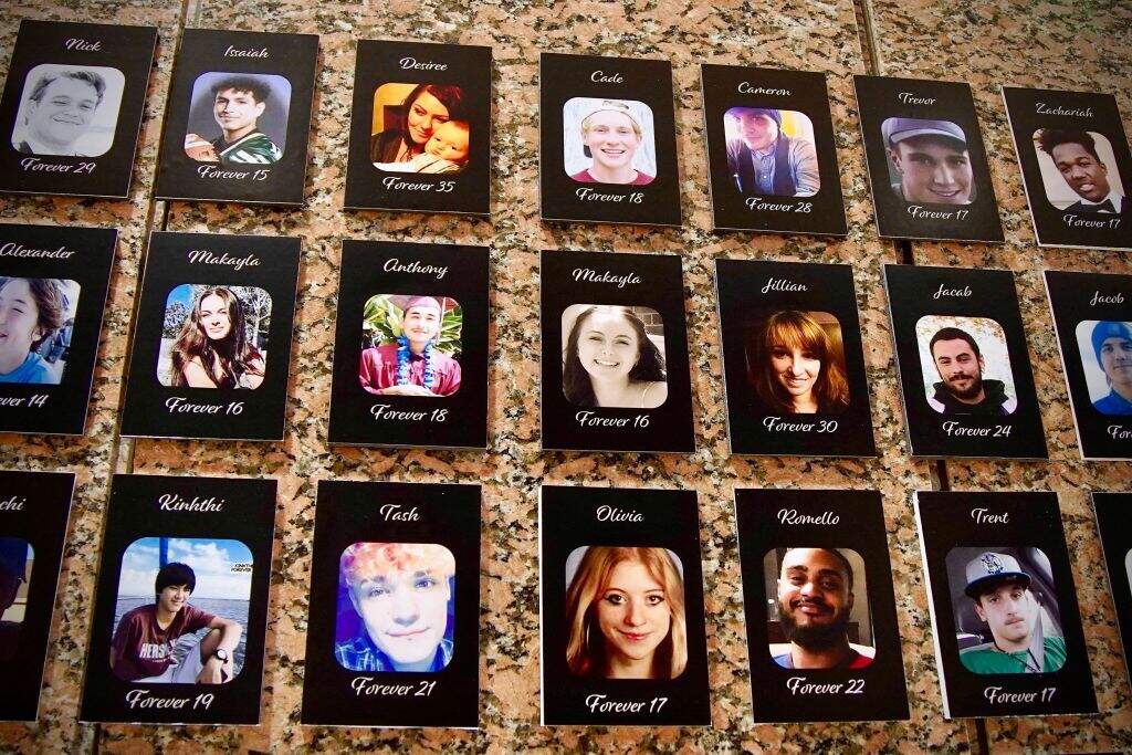 Photos of Americans who died from a fentanyl overdose are displayed at the Drug Enforcement Administration (DEA) headquarters in Arlington, Virginia, on July 13, 2022. (Photo by AGNES BUN/AFP via Getty Images)