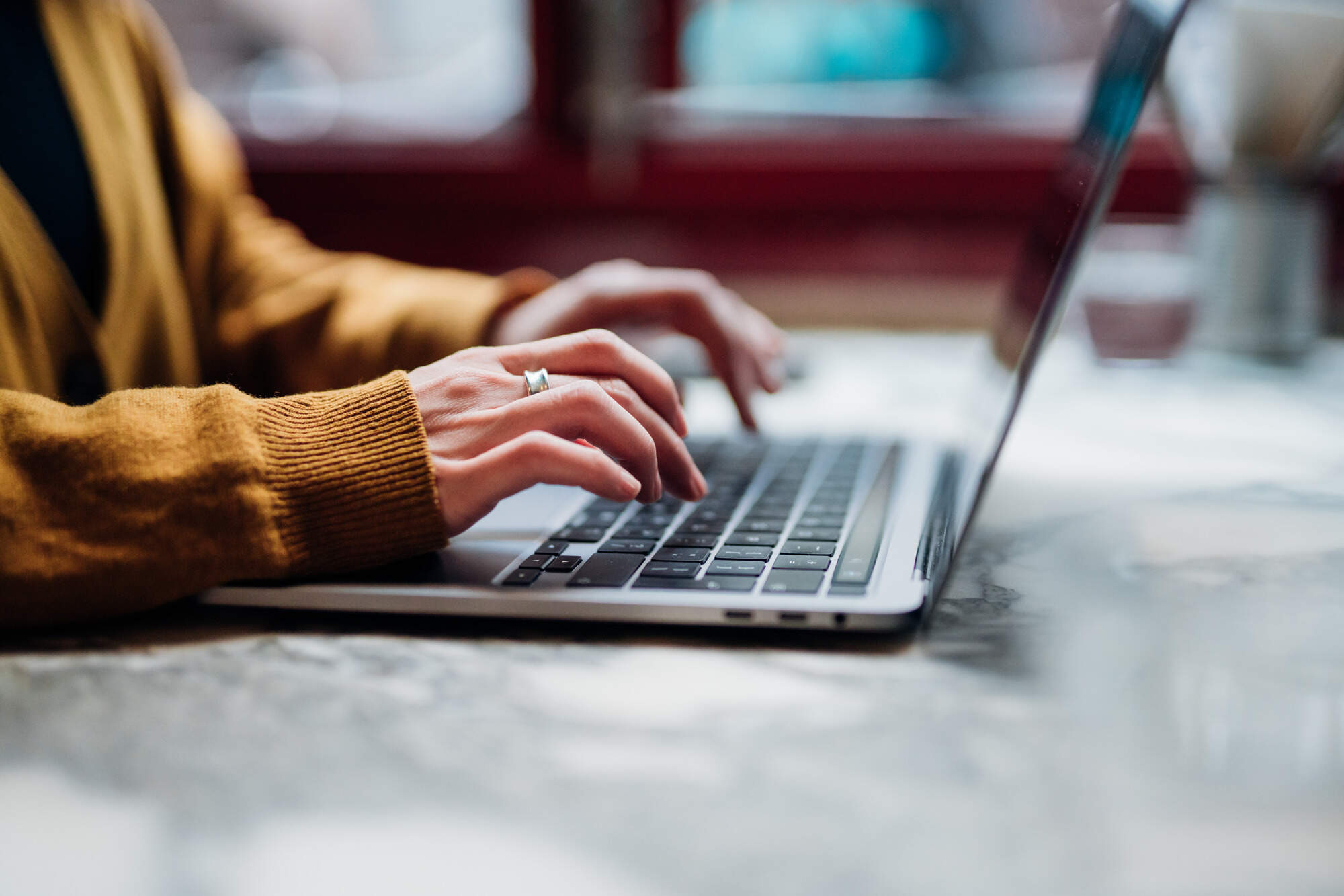 A woman types on a laptop. (Oscar Wong/Getty Images)