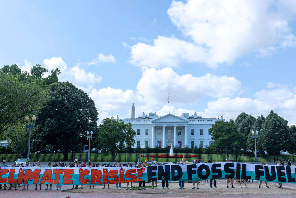 Climate activists chant as they occupy Lafayette Park with a 120 foot banner demanding President Biden act on climate change near the White House on July 04, 2023 in Washington, DC. Temperatures in oceans around the world have recently been recorded at record highs. (Tasos Katopodis/Getty Images)