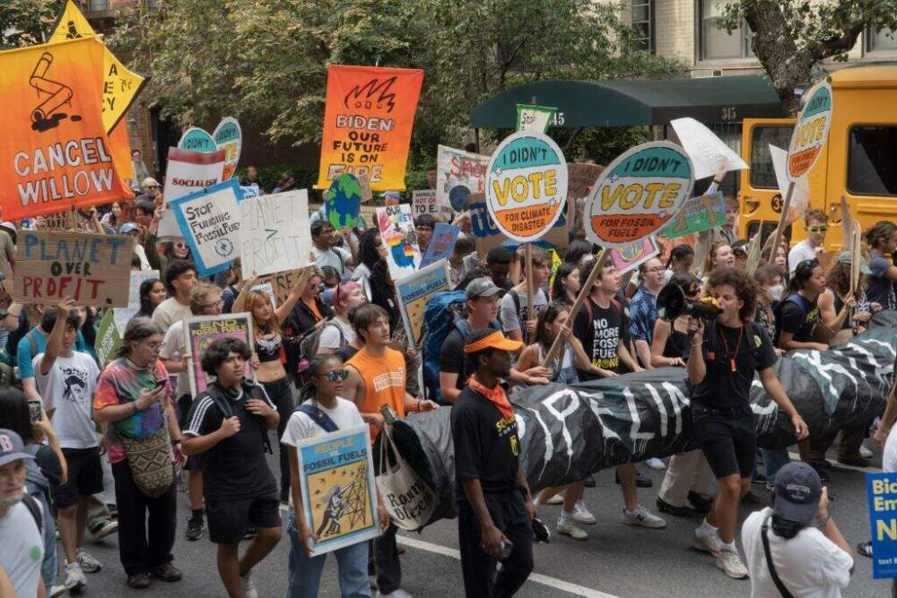 A large diverse group of young climate activists carry signs, and a piece of street art representing a pipeline, during the March to End Fossil Fuels, New York, New York. One uses a bullhorn to lead the marchers in chants.. (John B Senter III/UCG/Universal Images Group via Getty Images)