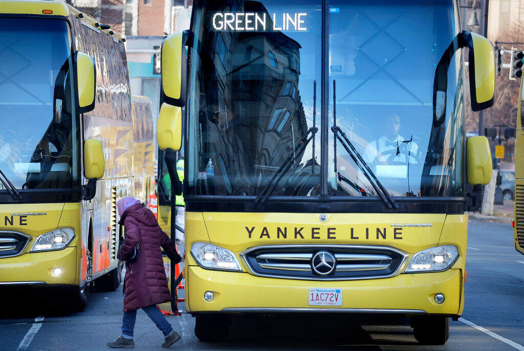 Passengers depart shuttle buses during last month's partial Green Line closure. (Lane Turner/The Boston Globe via Getty Images)
