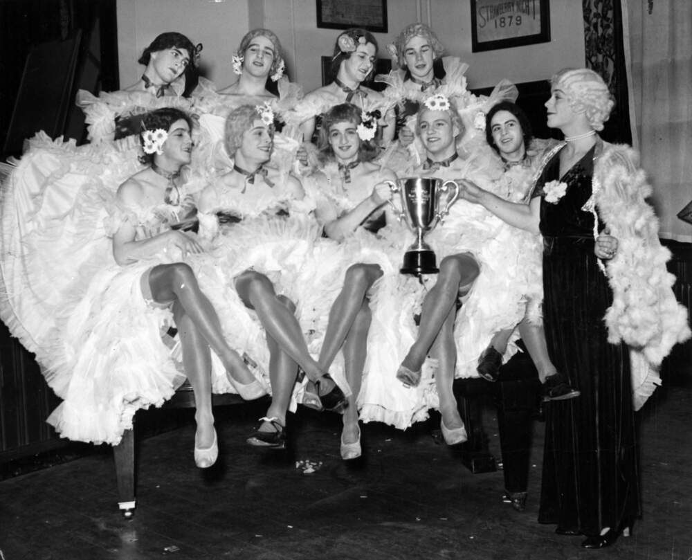 Gaspar G. Bacon Jr. presents a cup to George Earle IV for &quot;most beautiful girl in the chorus&quot; during a Hasty Pudding Theatricals show at Harvard University in Cambridge, April 1937. (The Boston Globe via Getty Images)
