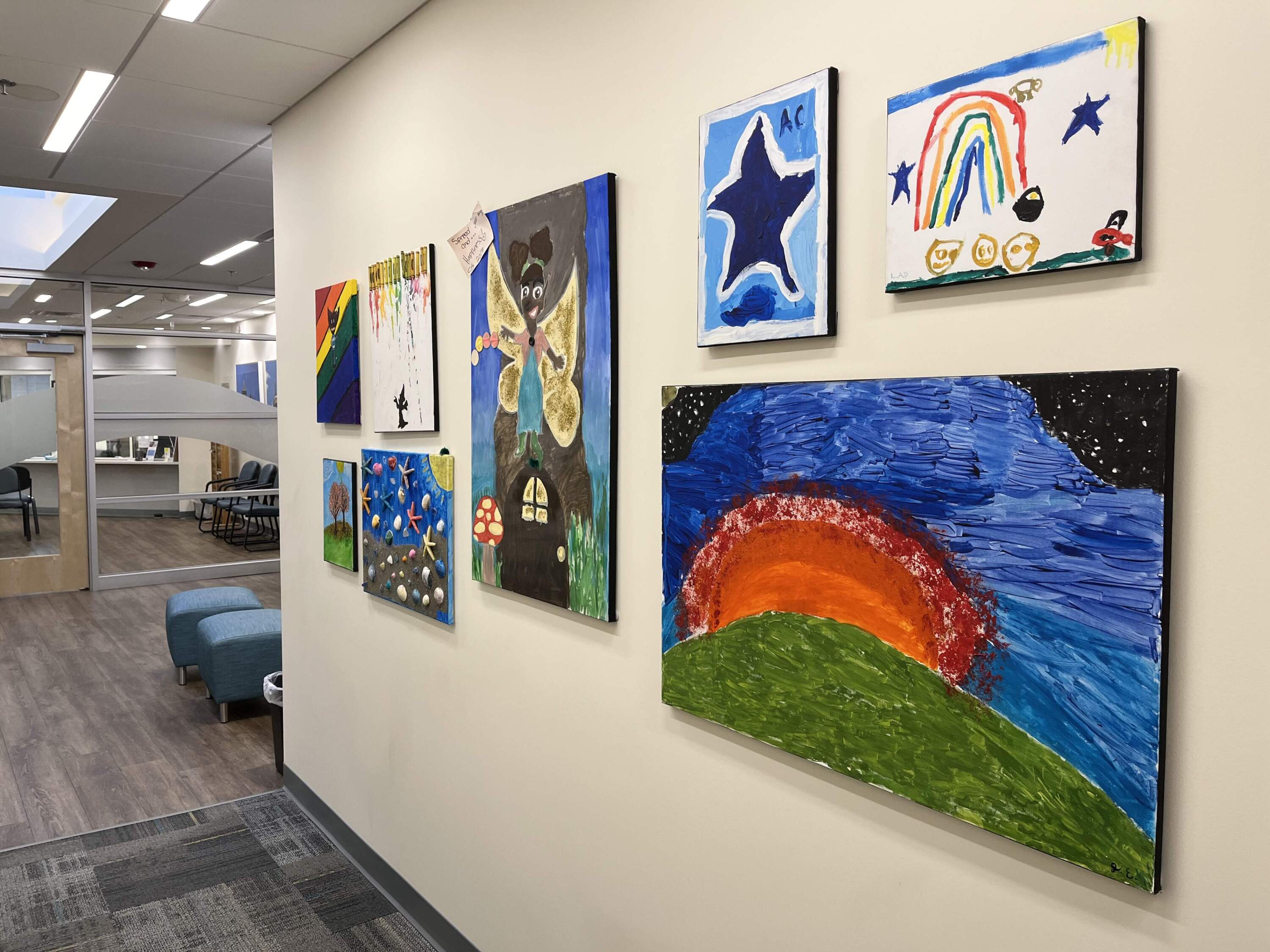 Artwork by kids who receive services at Riverside Community Care's CBHC in Milford decorates a hallway at the center. (Lynn Jolicoeur/WBUR)