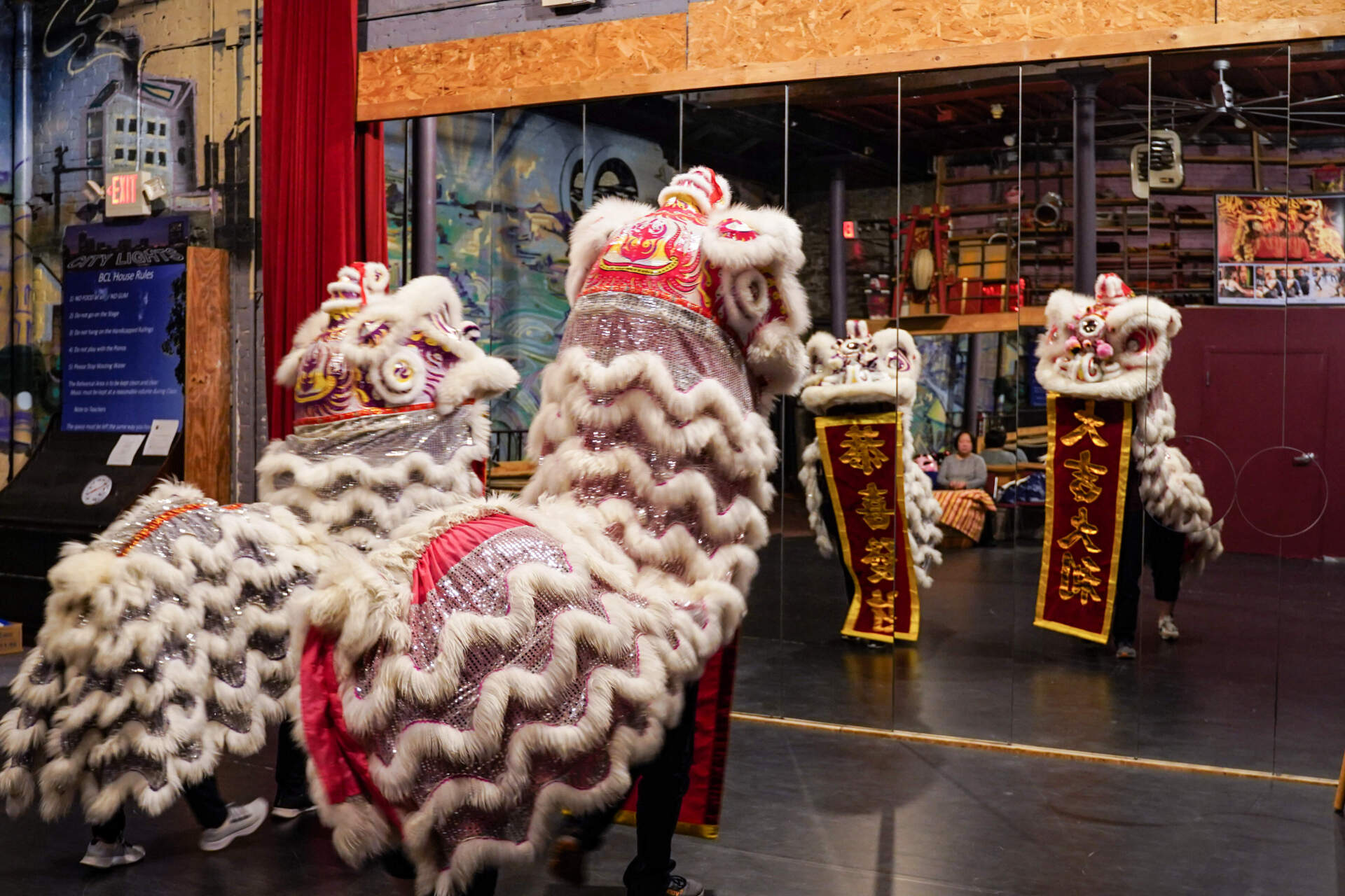 Members of the Nüwa Athletic Club practice for the lion dance performance at Pao Arts Center on Sunday. (Cici Yu/WBUR)