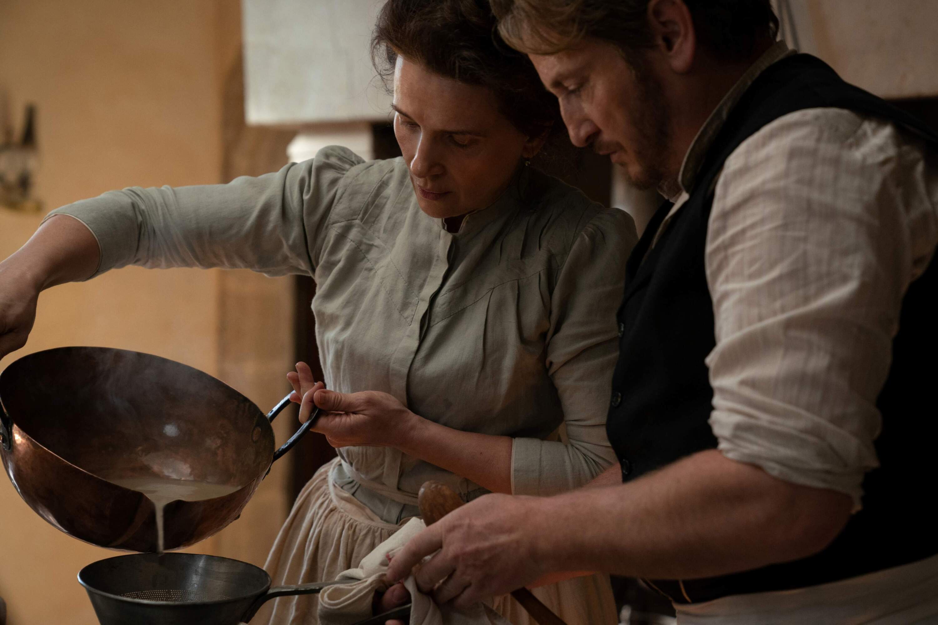 Juliette Binoche as Eugénie and Benoît Magimel as Dodin in "The Taste of Things." (Courtesy of Stéphanie Branchu/IFC Films)