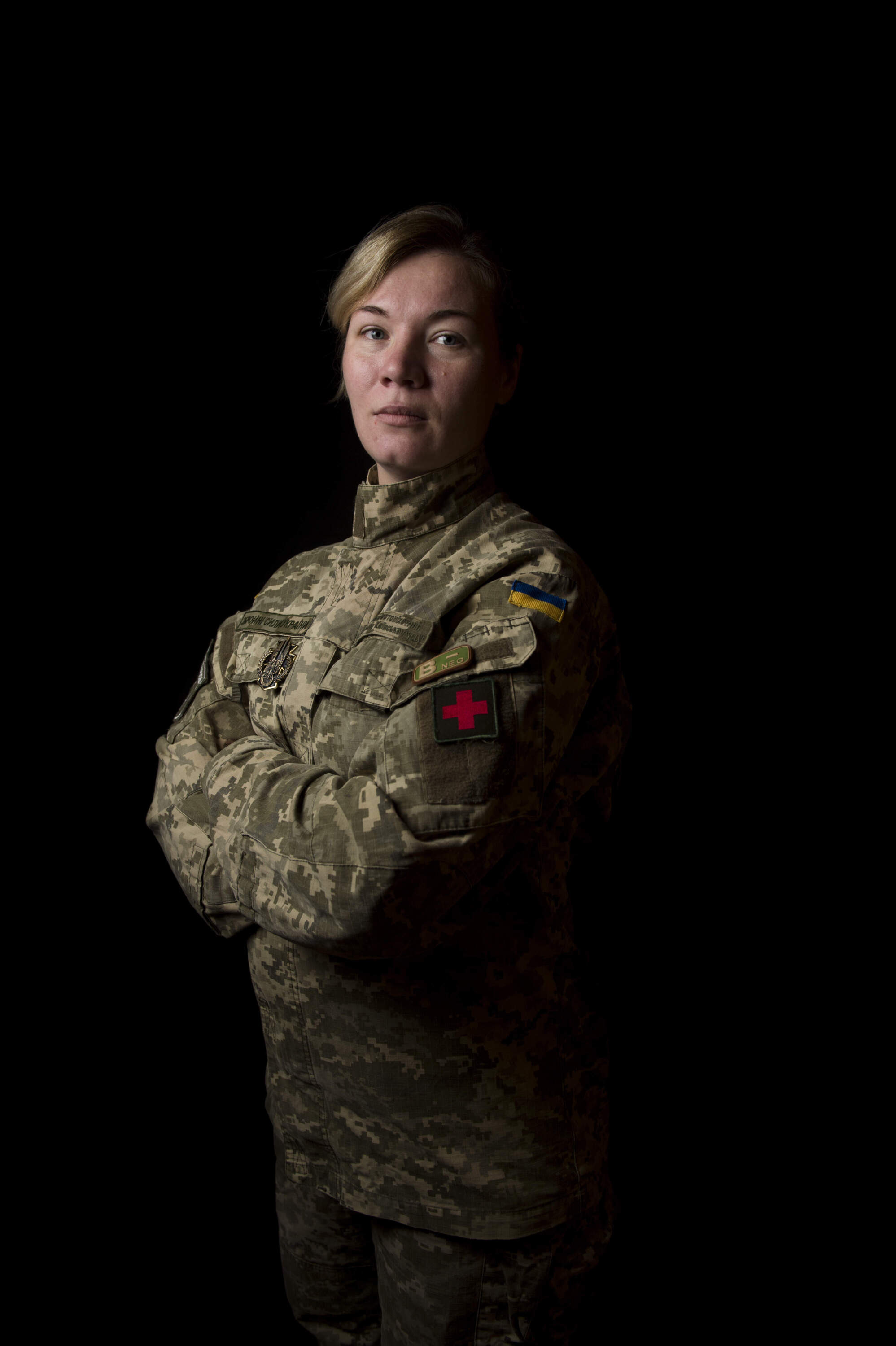 Portrait of Yevhenia “Eva” Yavchenko, Maidan revolutionary, a 2014 volunteer of the war in Eastern Ukraine. From Kyiv, Yevhenia ran a nail salon business before she became an active participant in the Euromaidan revolution. After the annexation of Crimea in 2014, she joined the 25th Battalion Kyivska Rus, a volunteer battalion created by her husband, working as a paramedic on the frontline during some of the most intense fighting of the war, including the battle of Debaltseve. She continued her service to the war collecting and delivering supplies to soldiers and children/schools in the conflict area and facilitating medical treatment for the children in the conflict zone, bringing them to camps outside the war where they are treated for medical injuries and receive psychological support. Yevhenia left shortly before the full-scale invasion in 2022 to protect her children. Photograph taken in Kyiv, Ukraine on October 5, 2018. (J.T. Blatty/Redux)