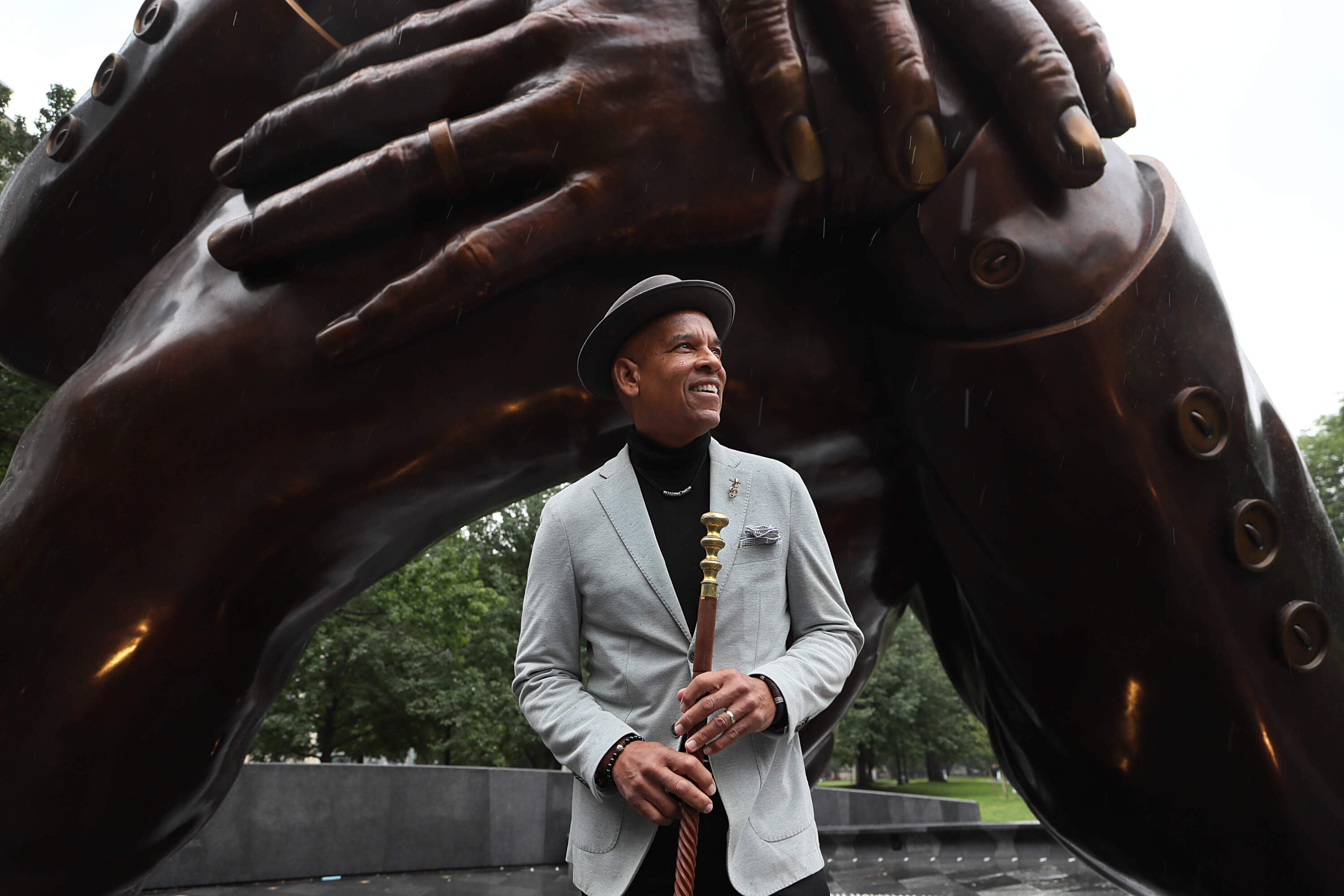 José Massó, host for nearly five decades of WBUR's ¡Con Salsa! stands before the Embrace monument on Boston Common. Massó's name is inscribed in the 1965 Freedom Plaza encircling the sculpture. (Suzanne Kreiter/The Boston Globe via Getty Images)