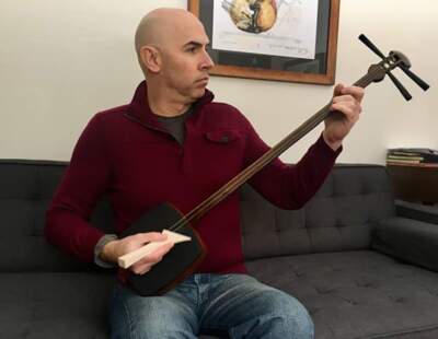 Eric Shimelonis plays the shamisen, which musicians appreciate for its special ability to make both bold and delicate sounds.