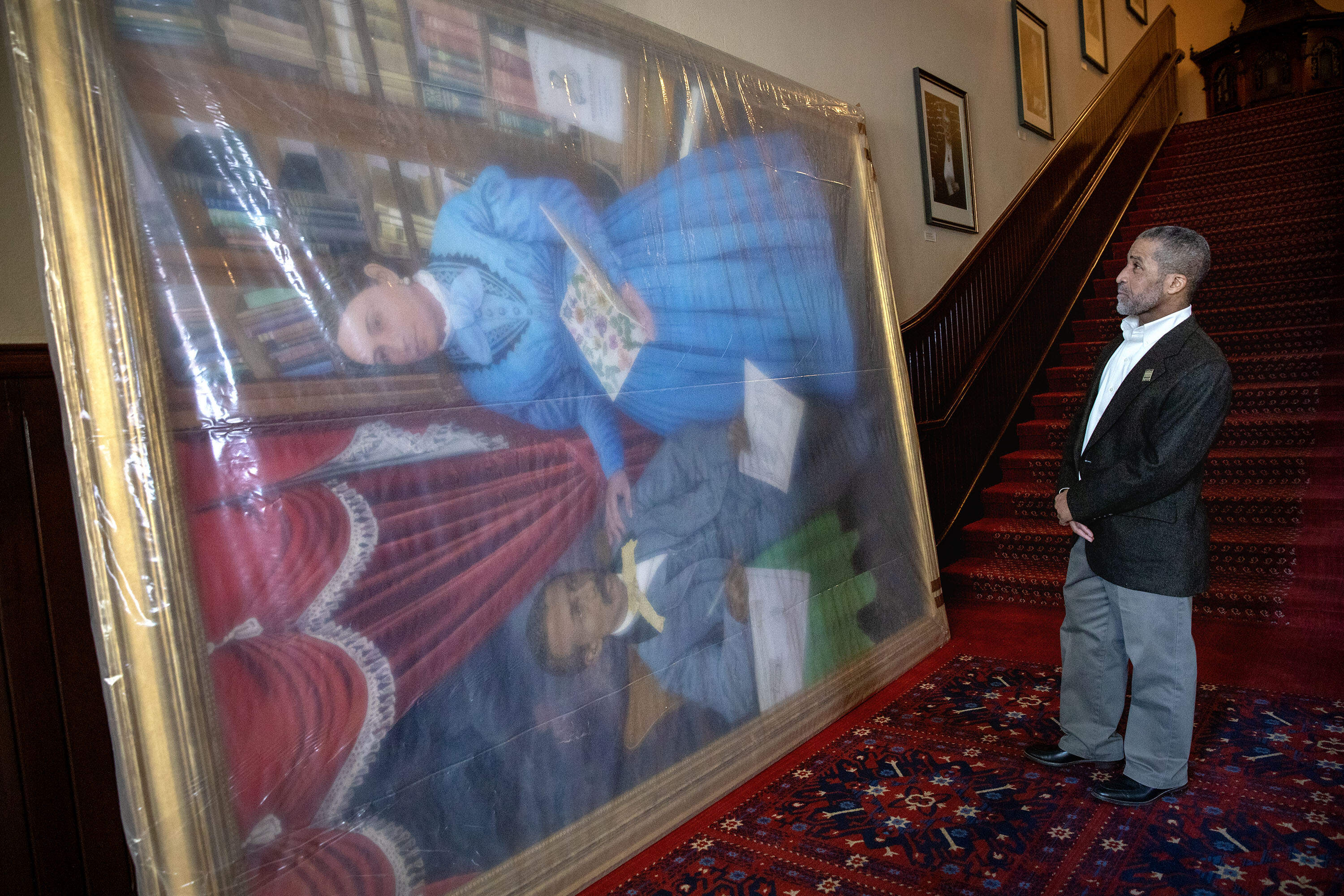 James Goldsberry, a great-great-grandson of William and Martha Brown, looks the new portrait of his great-great-grandparents as it arrives at Mechanics Hall in Worcester. (Robin Lubbock/WBUR)