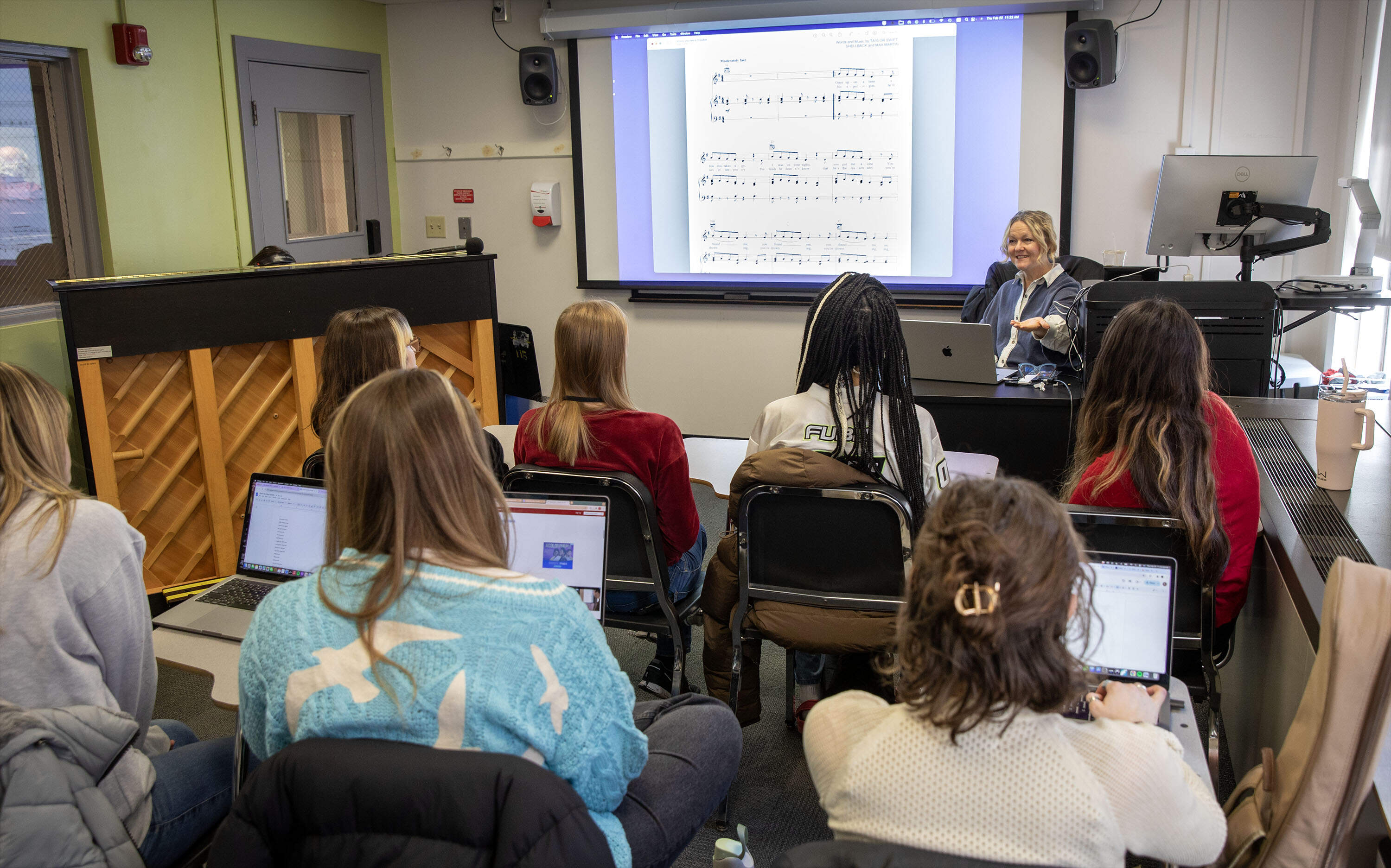 Songwriting professor Scarlet Keys talks with her students during her Taylor Swift class at Berklee College of Music. (Robin Lubbock/WBUR)