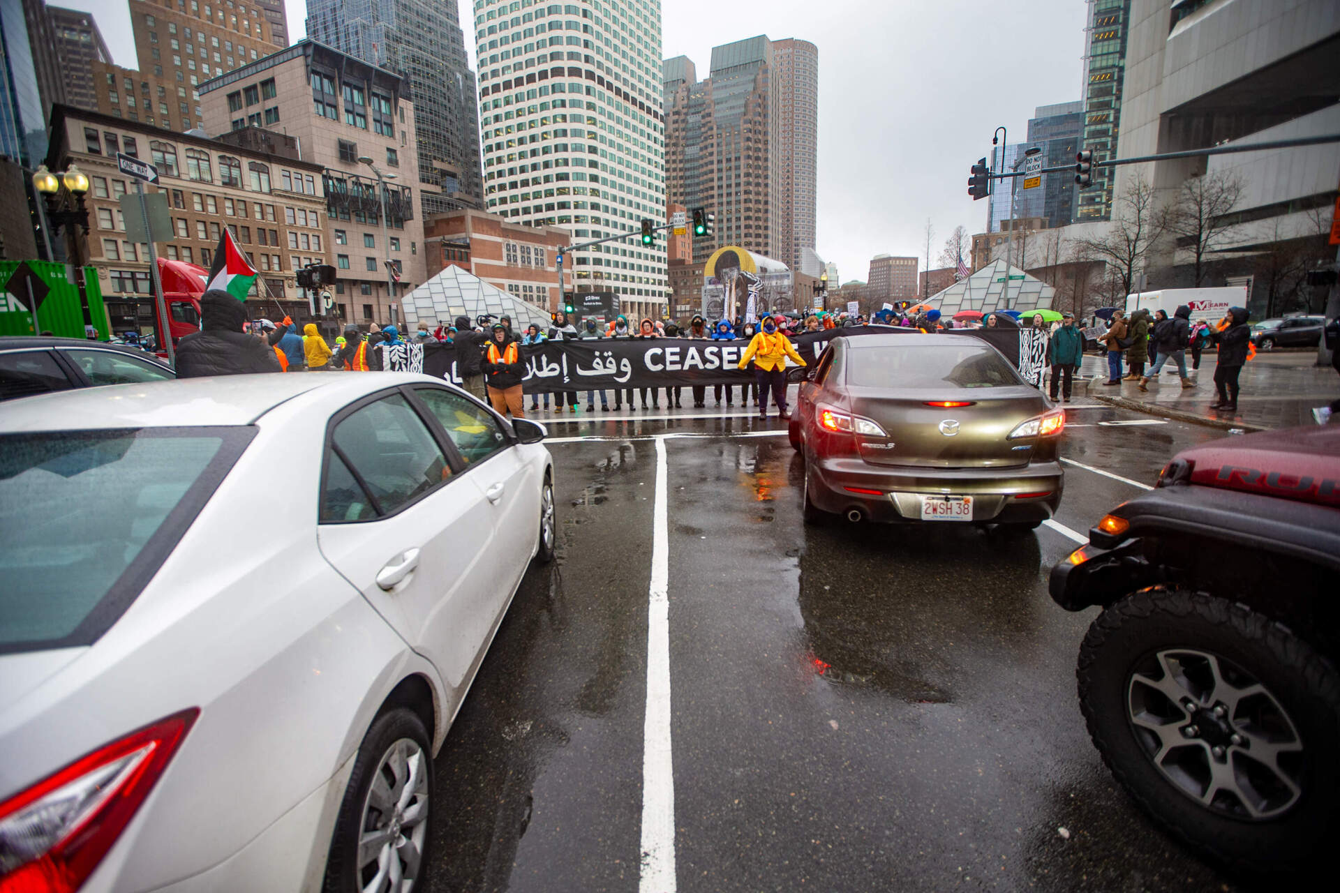 Members of IfNotNow Boston block commuters' paths on Atlantic Avenue. (Jesse Costa/WBUR)