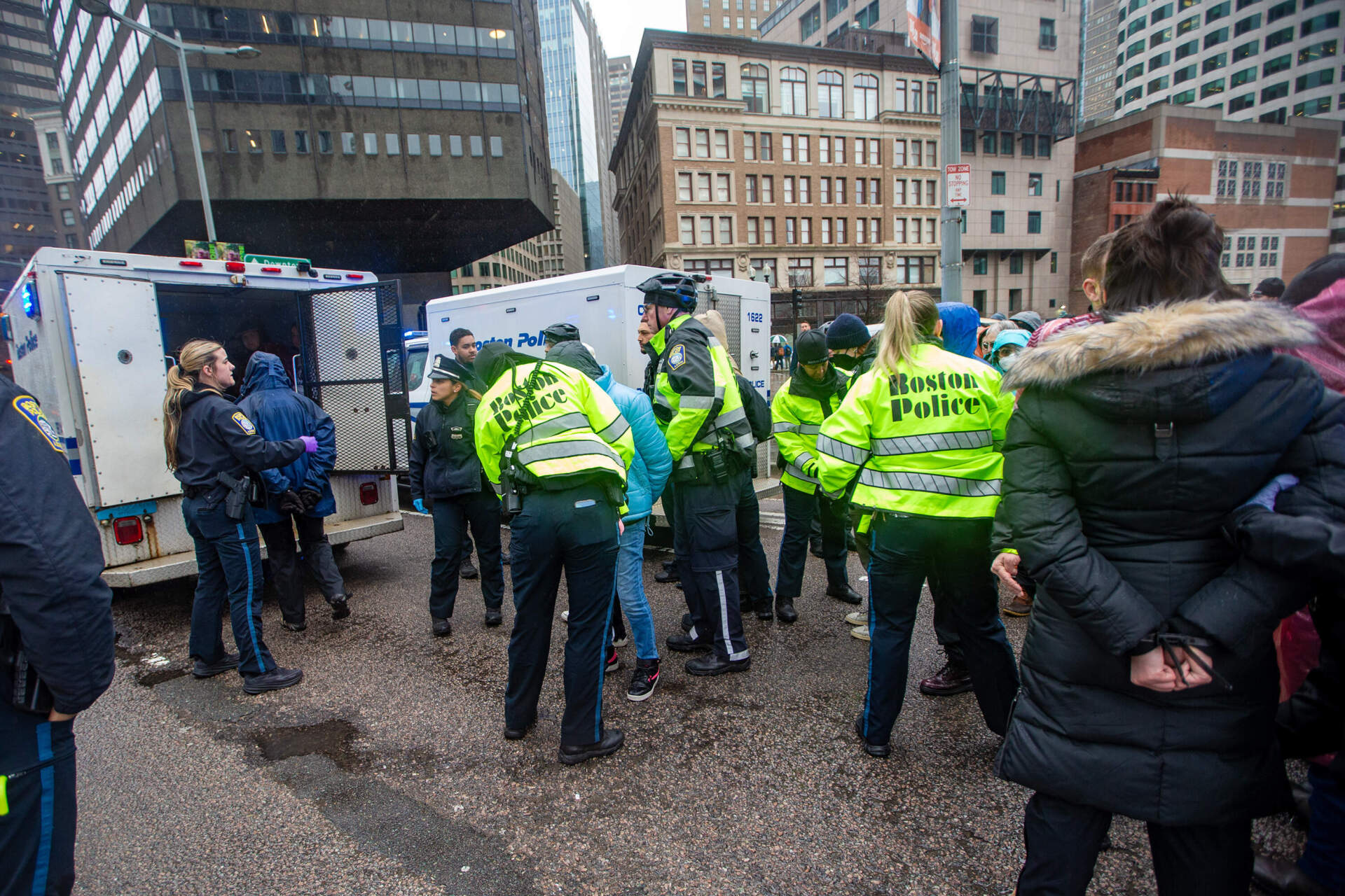 Boston police usher arrested protesters into police vehicles. (Jesse Costa/WBUR)