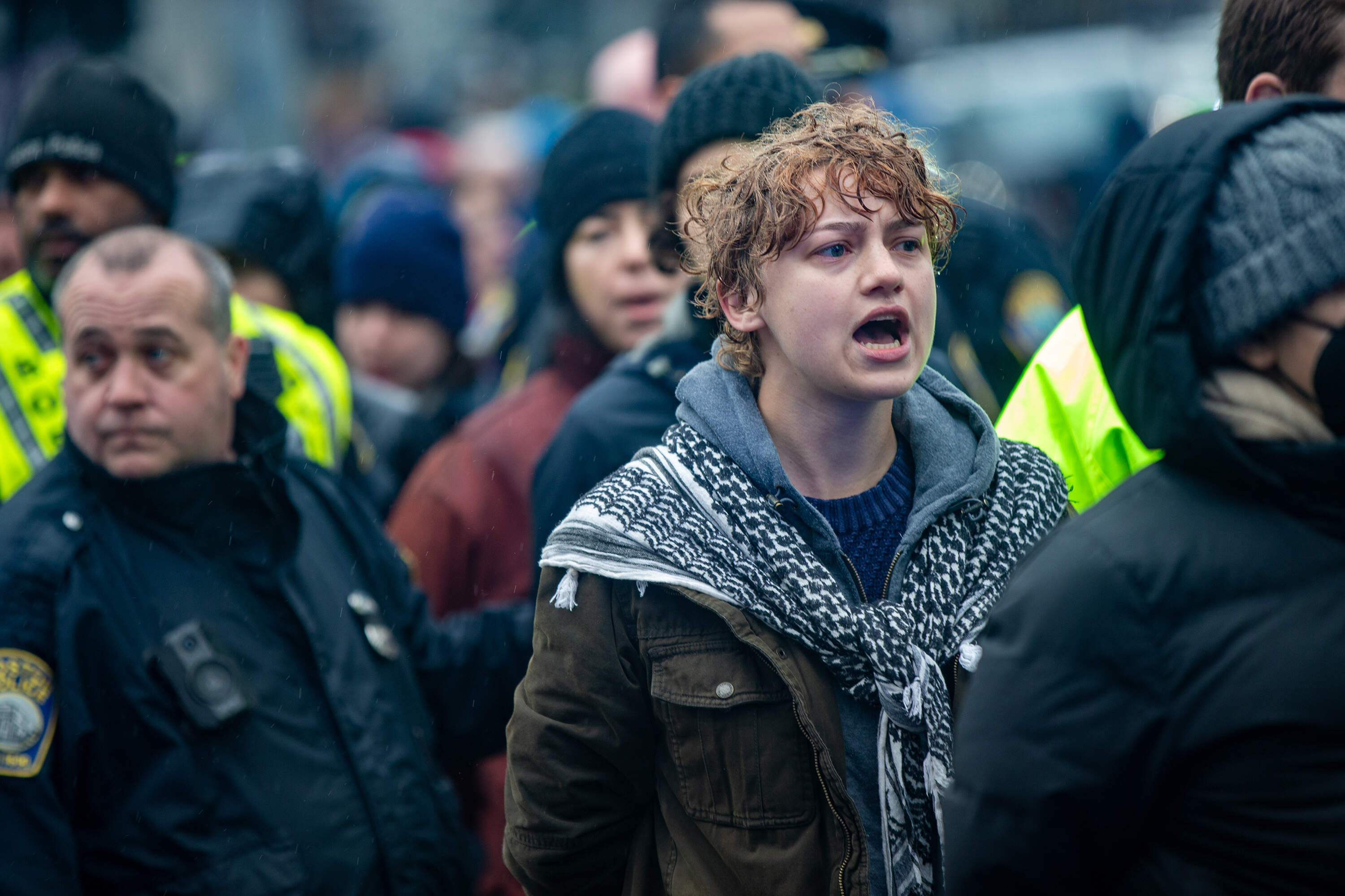 Protesters stand in line chanting “Free Palestine,” as they wait to be arrested by police in Dewey Square. (Jesse Costa/WBUR)