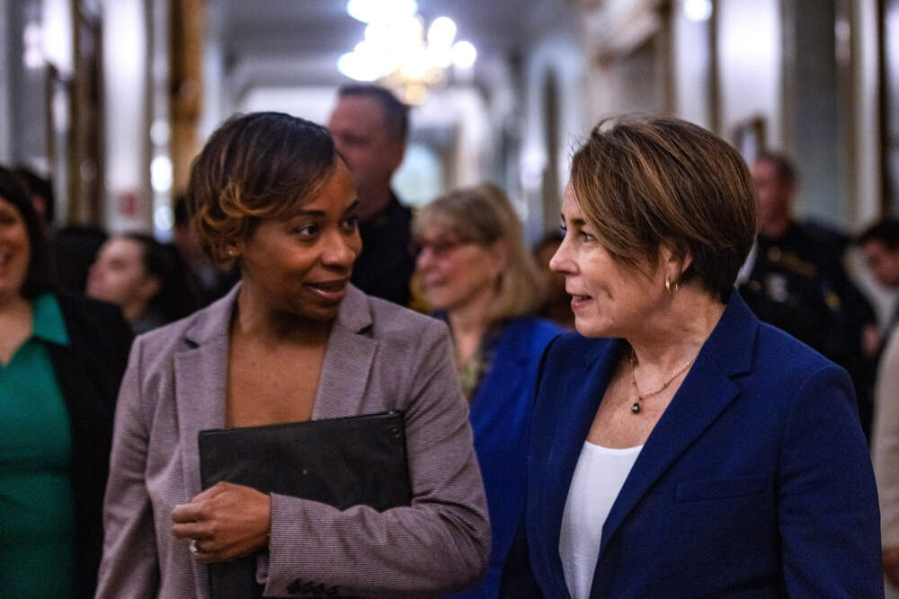 Attorney General Andrea Campbell and Governor Maura Healey walk together toward the press conference to announce Healey's executive action to pardon misdemeanor marijuana possession convictions in Massachusetts. (Jesse Costa/WBUR)