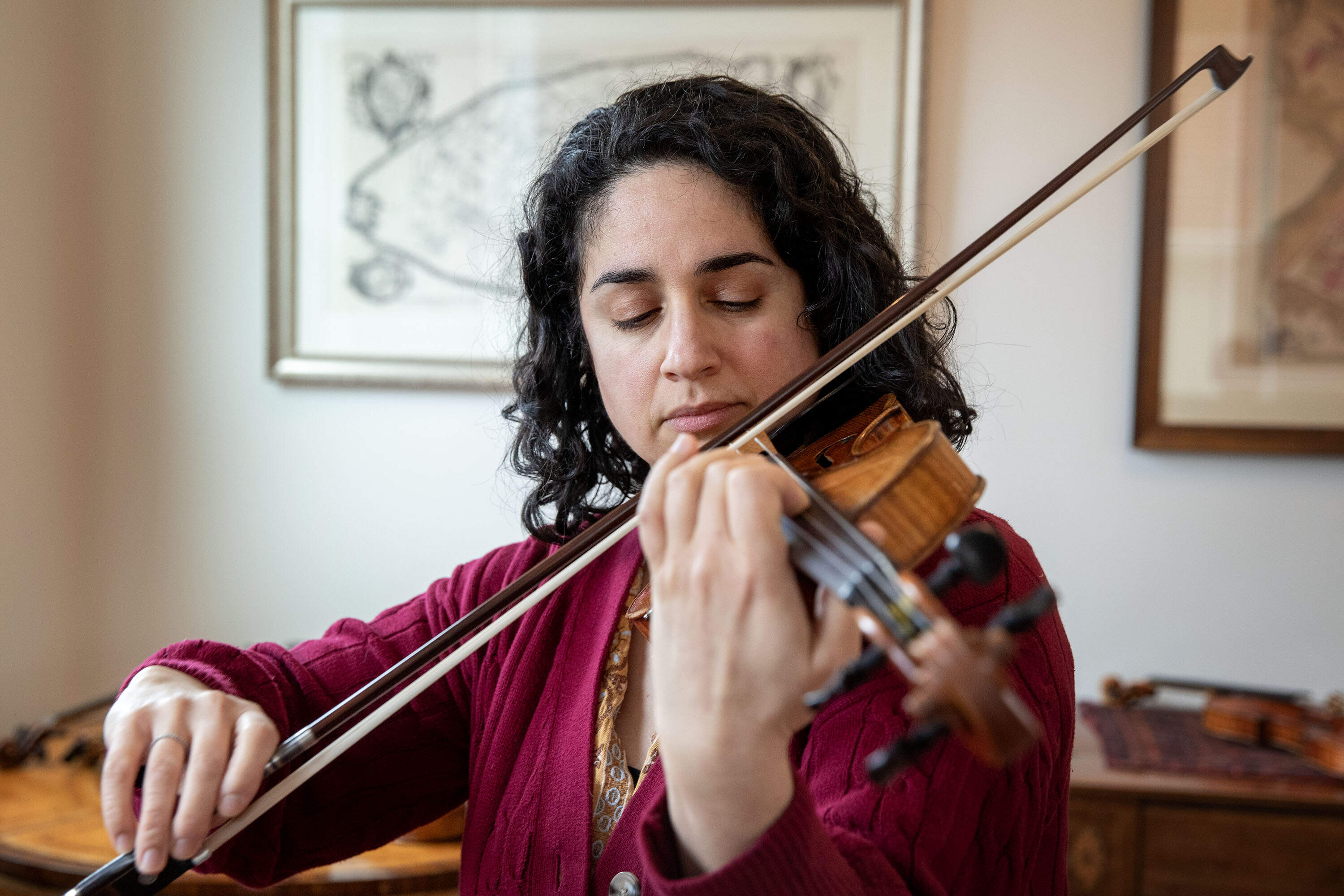 Violinist Annie Rabbat plays an antique violin at Reuning &amp; Son Violins. (Robin Lubbock/WBUR)