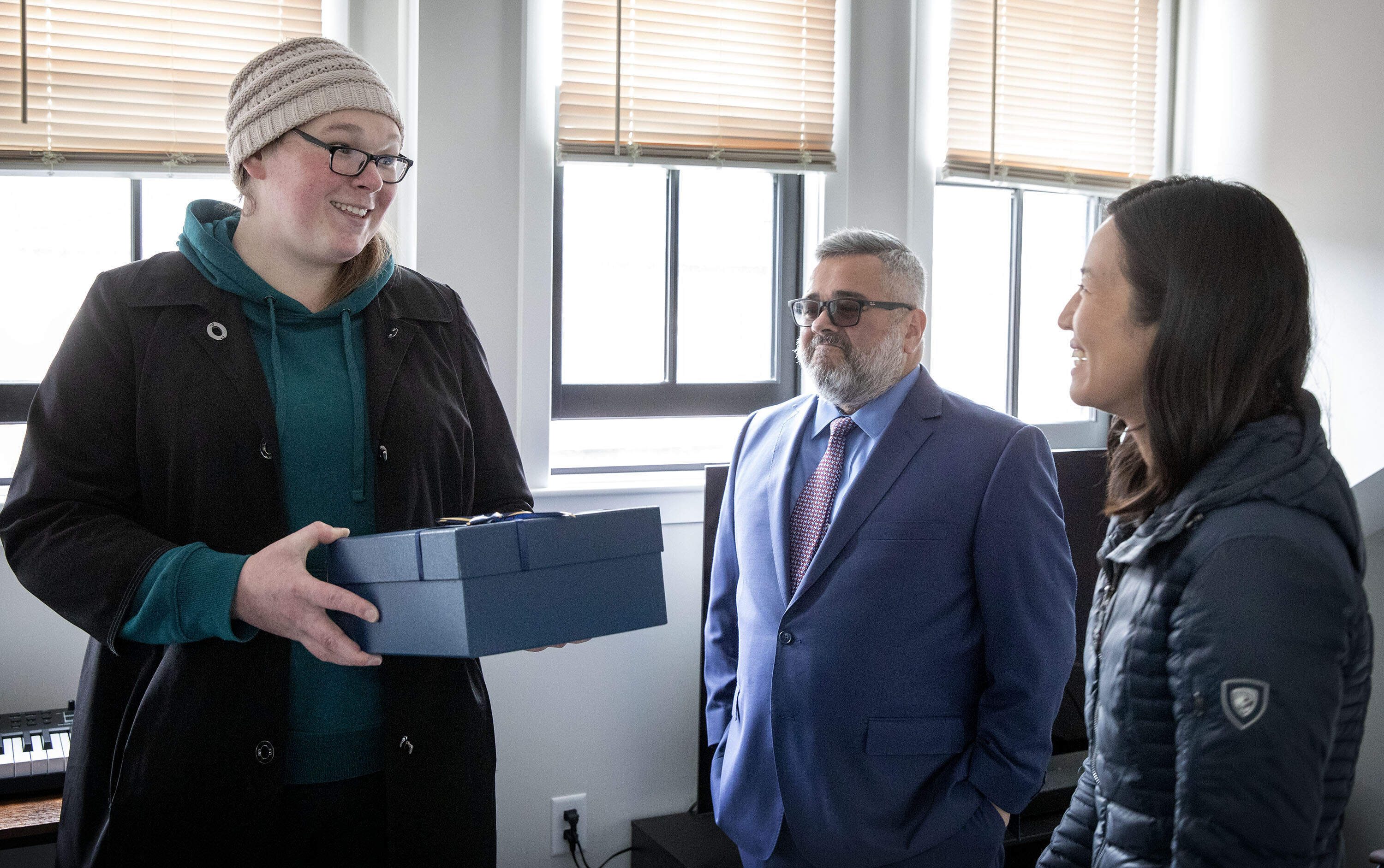 Veteran Marissa Troupe accepts a housewarming gift from Mayor Michelle Wu. (Robin Lubbock/WBUR)