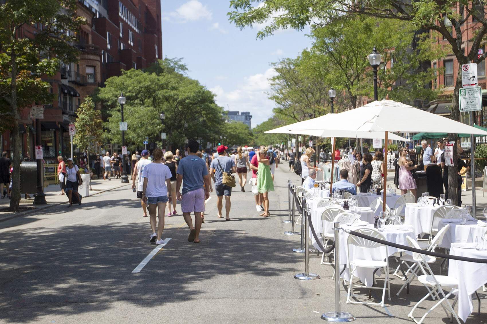 Pedestrians walk in the road on Newbury Street as a part of Open Newbury in 2016. (Joe Difazio/WBUR)