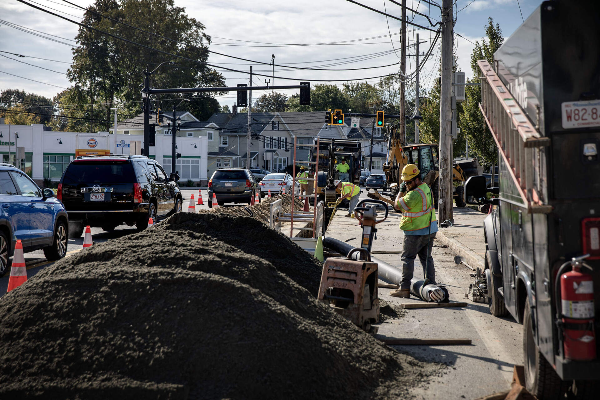 Workers lay geothermal pipe along Concord Street for Eversource's networked geothermal pilot project in Framingham. (Robin Lubbock/WBUR)
