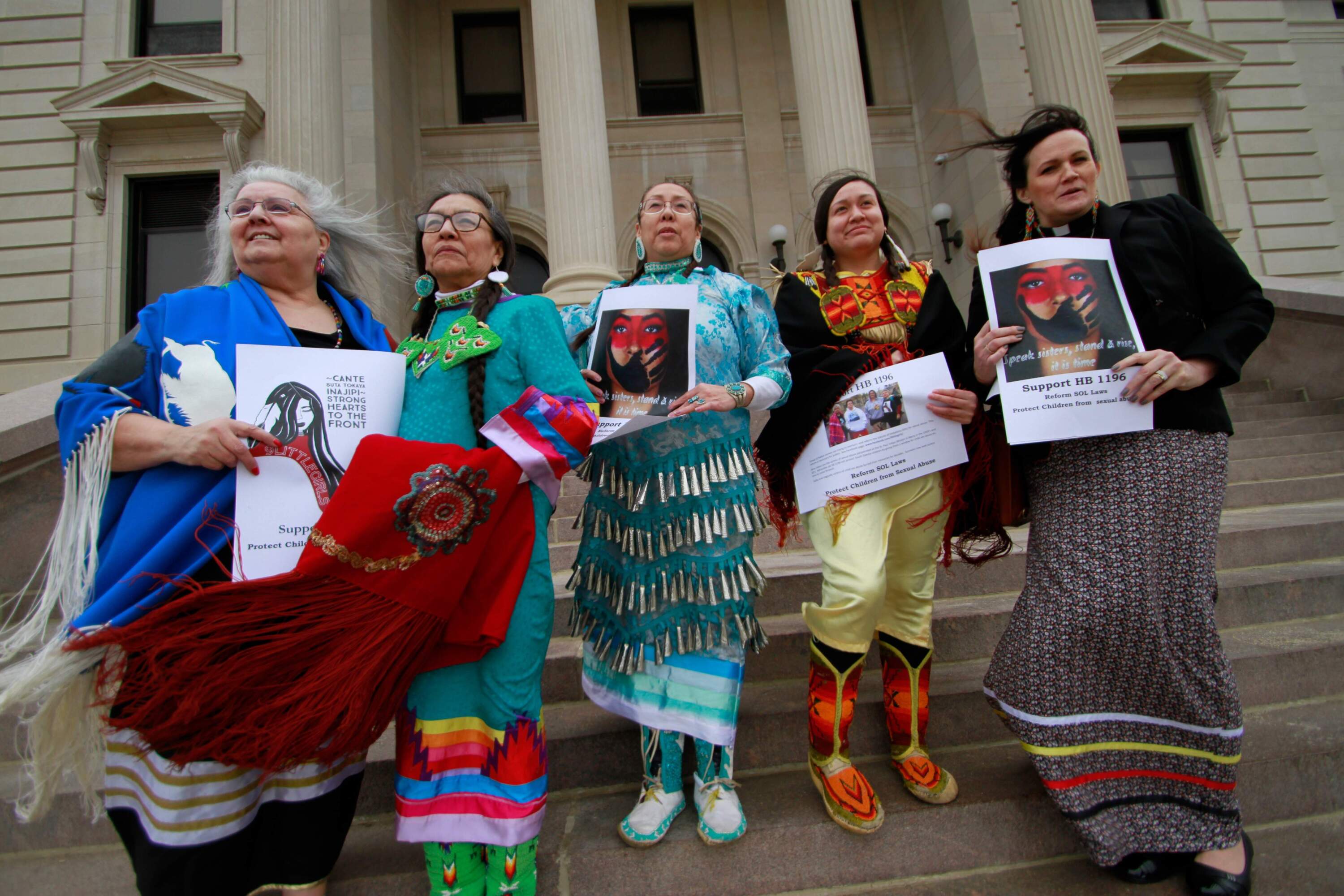 From left, Geraldine Dubourt, Francis Hart, Marie Ogitchida, Mikayla Maxwell and Michelle Dauphinais Echols stand on the steps of the South Dakota Capitol in Pierre, S.D. on Monday, Feb. 24, 2020. Lawmakers killed a bill that would have given survivors of childhood sexual abuse a two-year window to sue organizations in which abuse occurred. (Stephen Groves/AP)