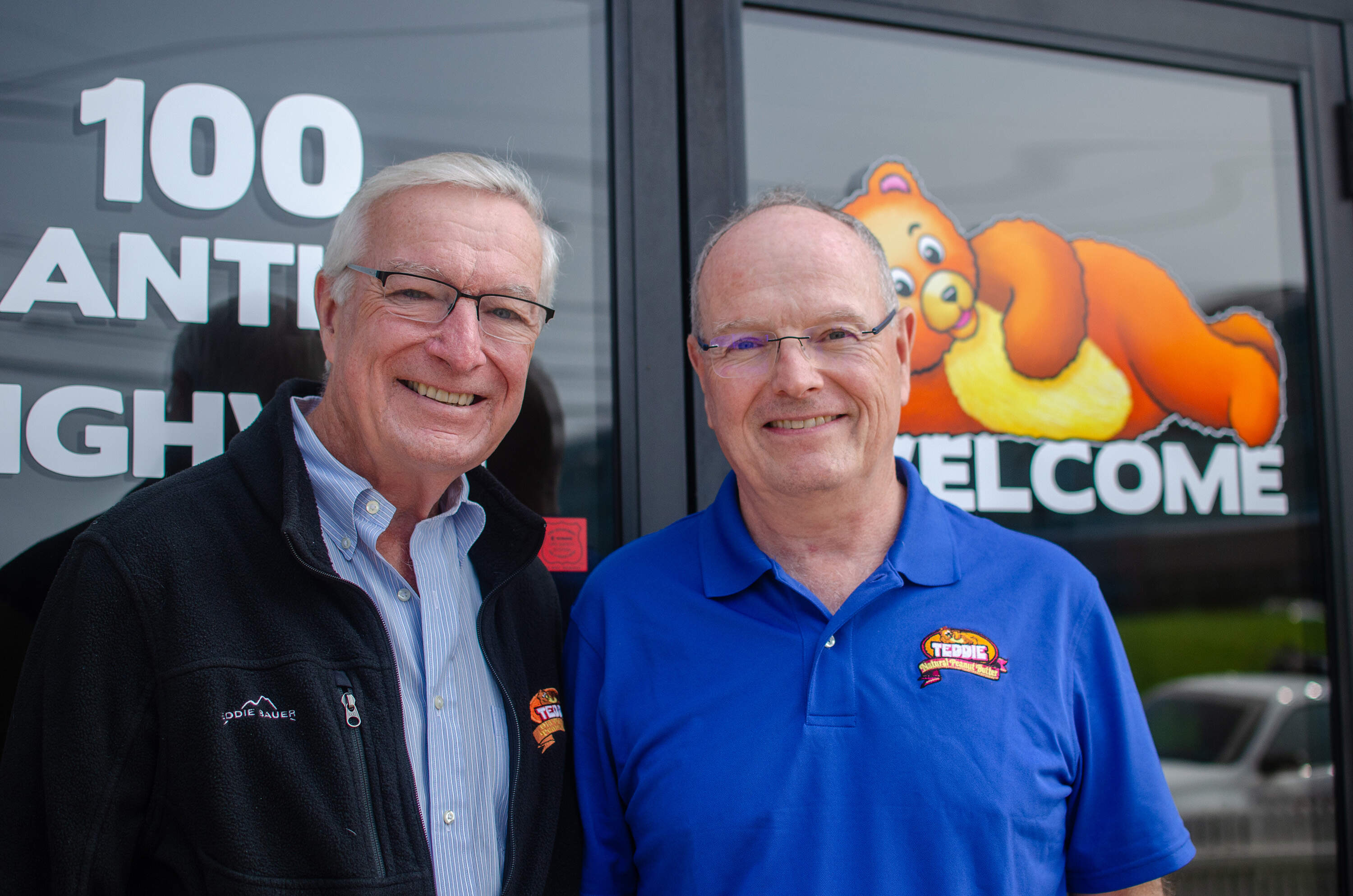 Former Teddie CEO and current Teddie consultant Mark Hintlian, and his brother, current CEO Jamie Hintlian, outside the Teddie factory in Everett. (Sharon Brody/WBUR)