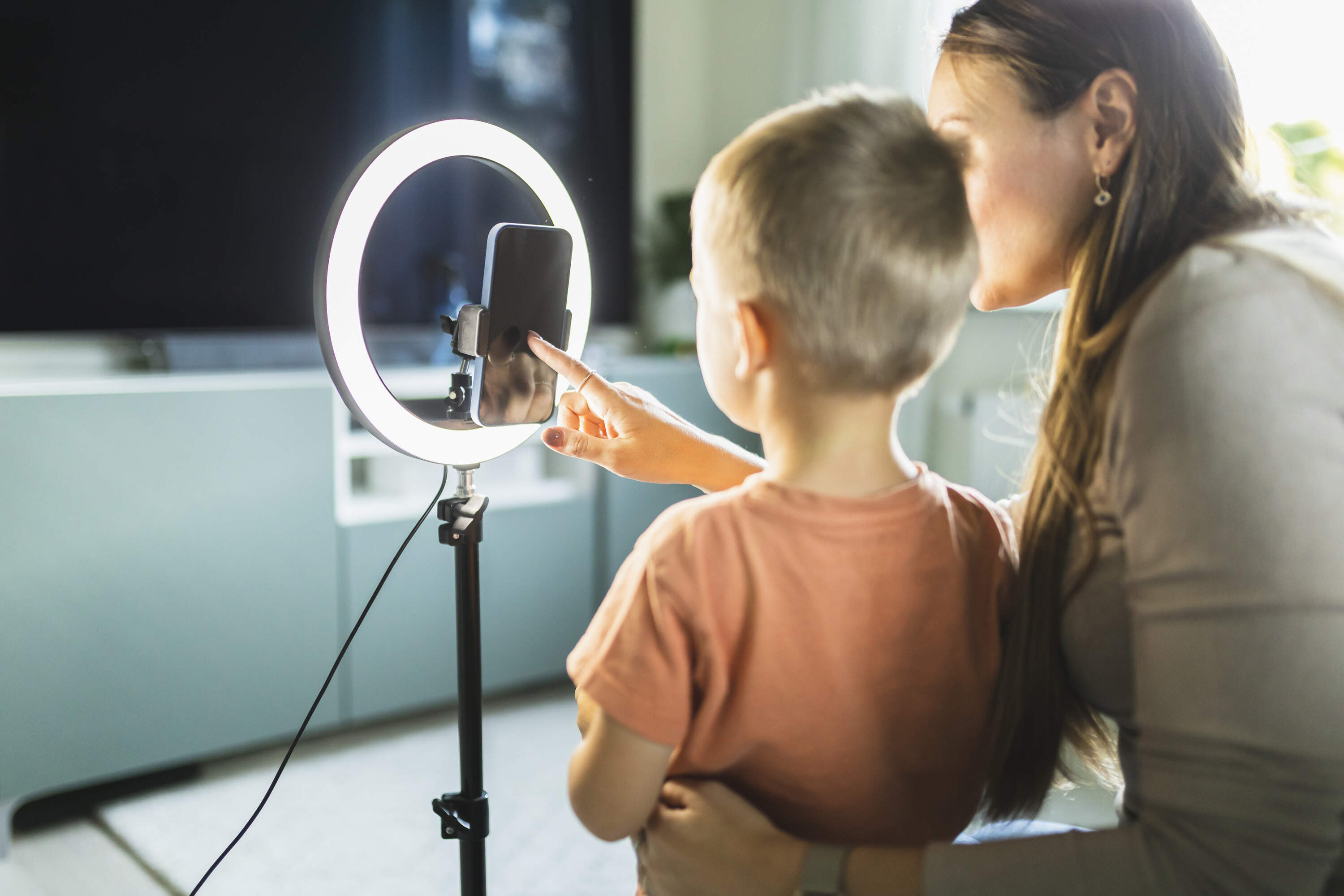 A mother livestreams with her child. (Getty Images)