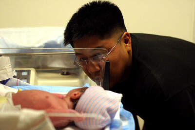 A father and his newborn at Holy Cross Hospital, which handles virtually all of the prenatal care and births of uninsured women in Montgomery County, Md., a significant majority of whom are immigrants. (Michael Robinson-Chavez/The Washington Post via Getty Images)