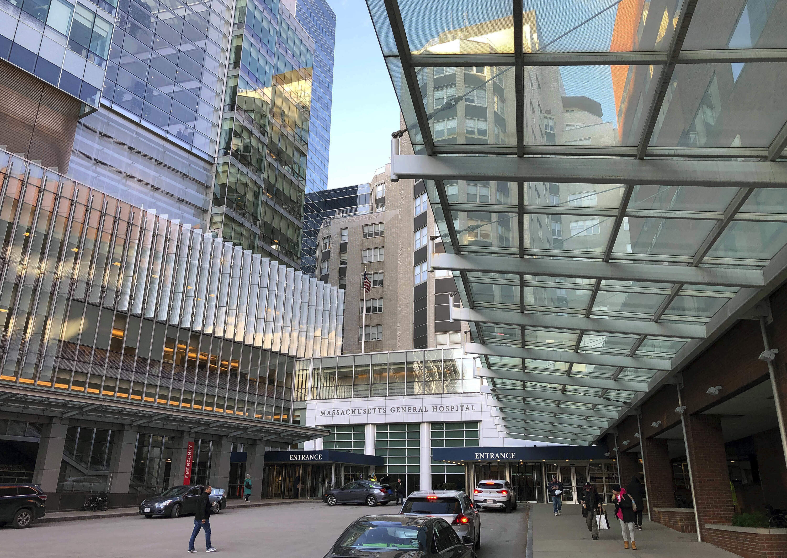 People walk near the entrance of Massachusetts General Hospital in Boston. (Bill Sikes/AP)
