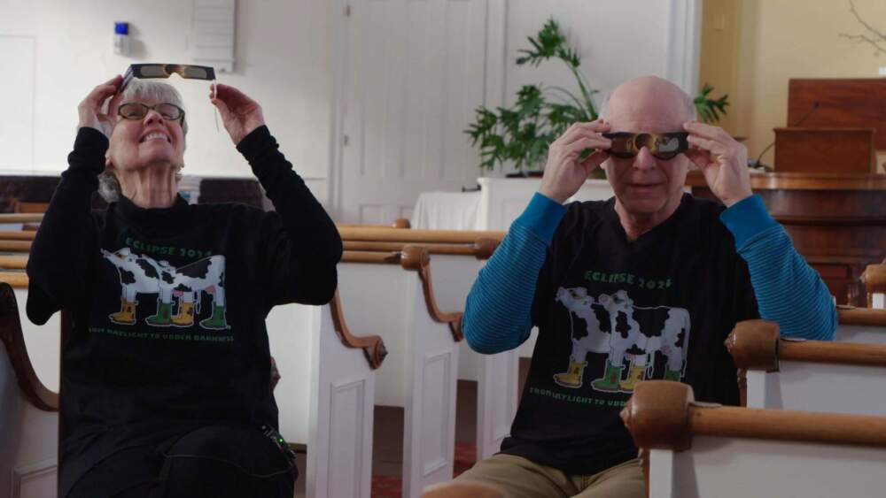 The solar eclipse, which will last a couple minutes, could generate between $10 million to $20 million in out-of-state spending, according to estimates from the Department of Tourism and Marketing. Susan Ogden and Mark Kuprych have been preparing by organizing a fundraiser at their Burlington church. (Joey Palumbo and Kyle Ambusk/Vermont Public)