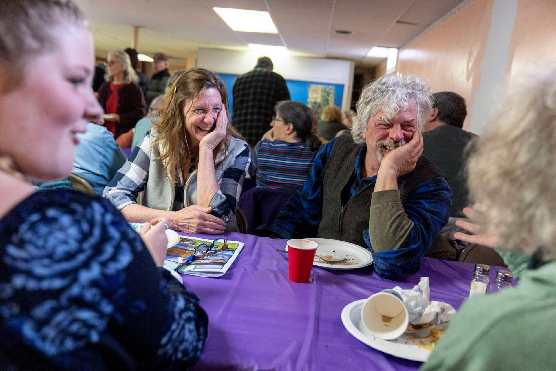 Nancy Davis, left, and Shorty Towne, right, talk with fellow residents during a pot luck luncheon following the annual Town Meeting, Tuesday, March 5, 2024, in Elmore, Vt. After nearly four hours, Town Meeting adjoins and residents of all political background sit down for lunch at the United Methodist church across the street. (David Goldman/AP)