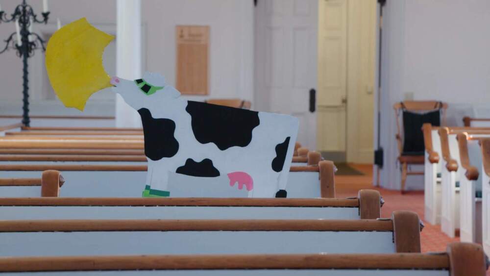 Sarah Rosedahl painted a cow for an eclipse-themed sermon. She also designed t-shirts for sale as part of the church's fundraiser. (Joey Palumbo and Kyle Ambusk/Vermont Public)