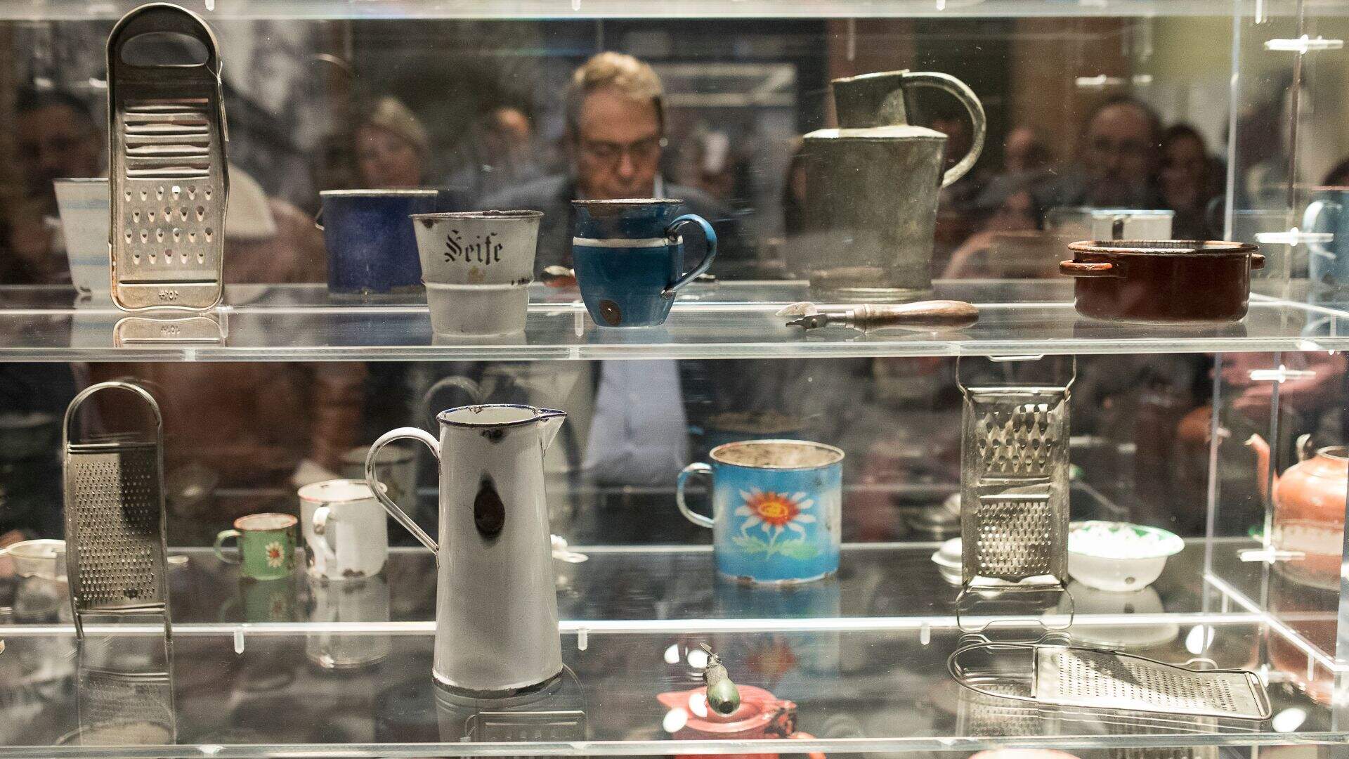 A visitor looks at a collection of items. (Courtesy Musealia)