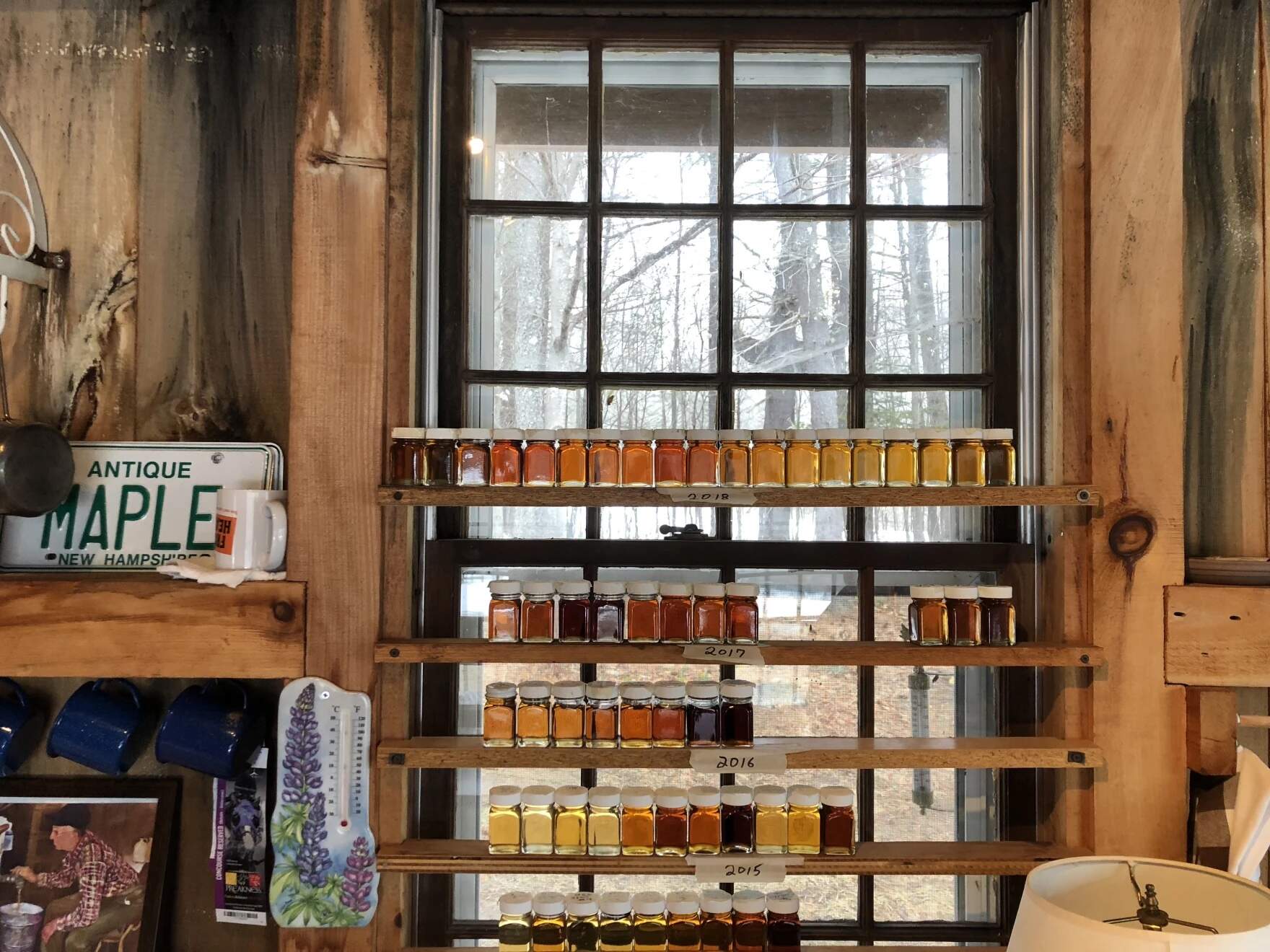 Syrup jars fill a window at Monadnock Sugar House in Jaffrey, New Hampshire. (Courtesy of Steve Roberge)