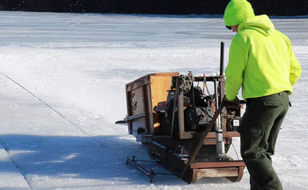 In years past, workers, and sometimes whole trucks, regularly fell through the ice during harvests. Neil Cederberg said one year, when he fell in with two other workers while standing on top of already-cut ice blocks, its was a strange, slow experience. “It’s like being in a dream,” he said “it’s just like falling through somebody’s mixed drink.” (Zoey Knox/NHPR)