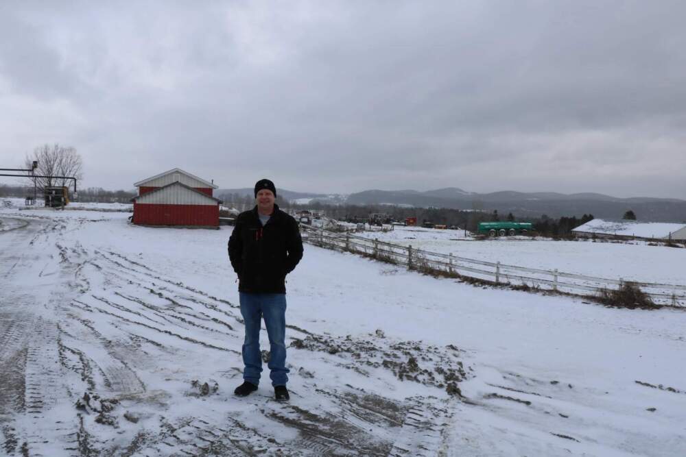 Matt Maxwell stands on his family's farm in Coventry. The land behind Maxwell was rented out to Phish for the 2004 two-day music festival. (Howard Weiss-Tisman/Vermont Public)