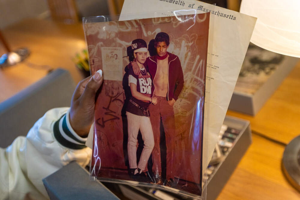 Ebony Gill holds up a photo from the archive at UMASS Boston's Healey Library. (Jesse Costa/WBUR)