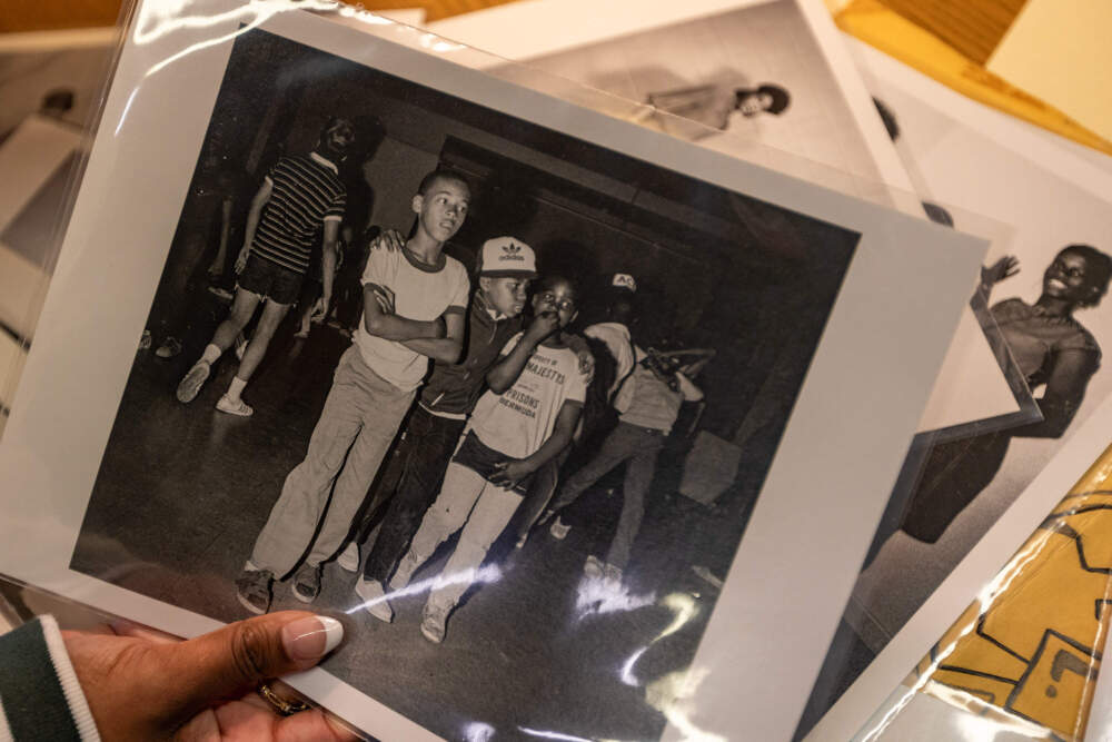 Ebony Gill holds a photo from UMASS Boston's Healey Library archive. (Jesse Costa/WBUR)
