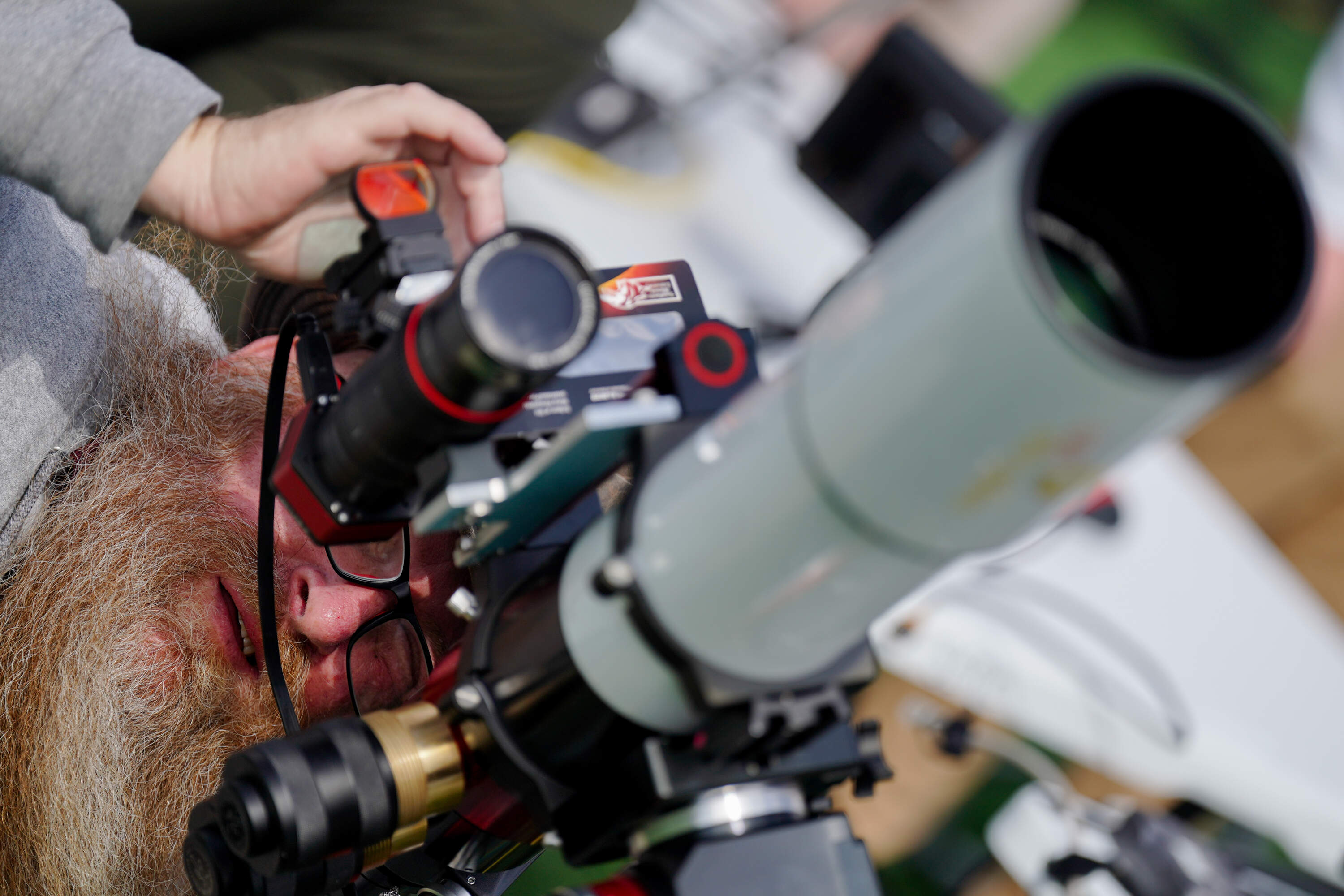 Chris Mandrell, the project coordinator for Southern Illinois University’s dynamic eclipse broadcast, focuses a telescope ahead of the total solar eclipse on Sunday, April 7, 2024. (Brian Munoz/STLPR)