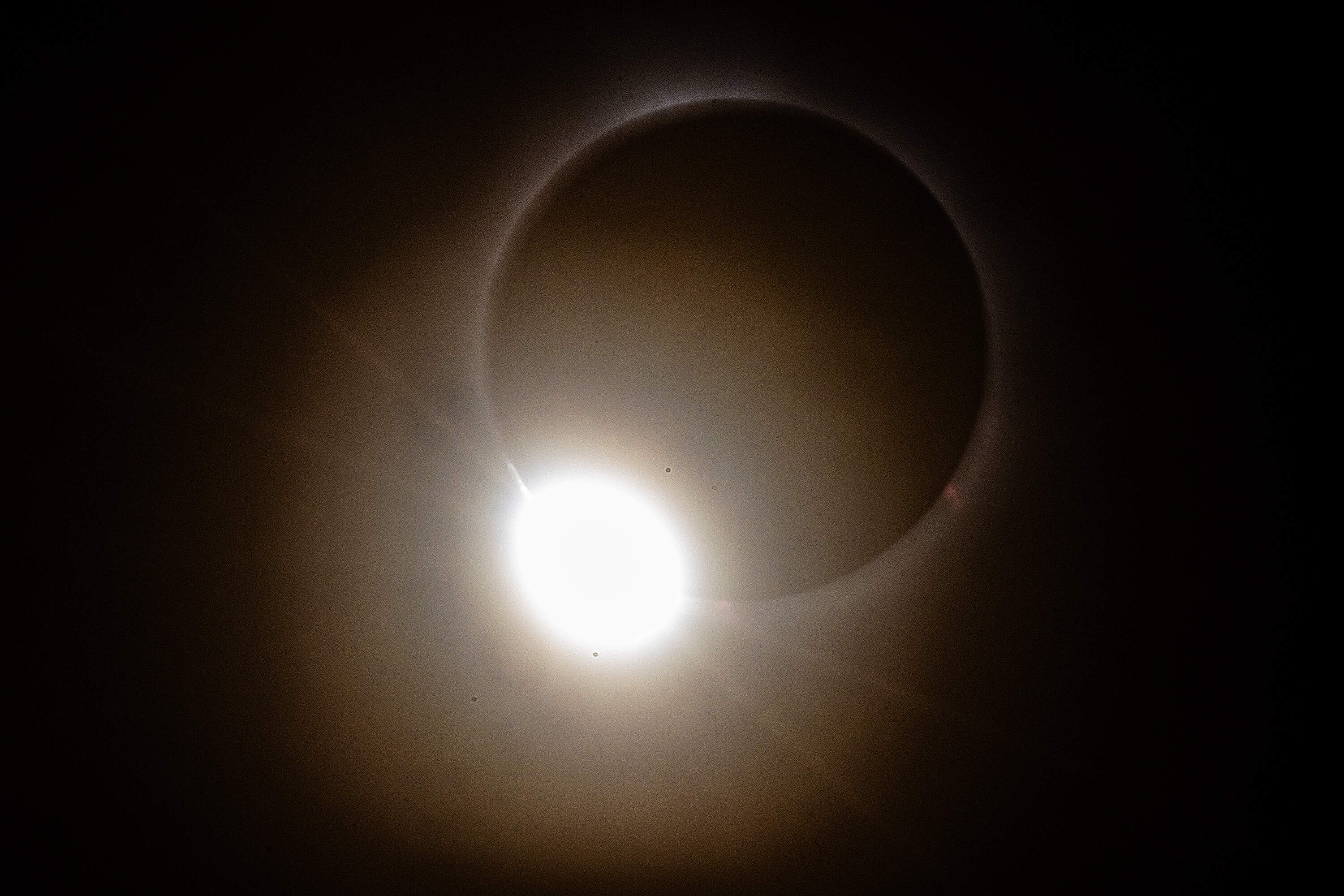 A "diamond ring" is seen as the moon moves away from the sun during the total solar eclipse as seen from Montpelier, Vermont on April 8, 2024. (Jesse Costa/WBUR)