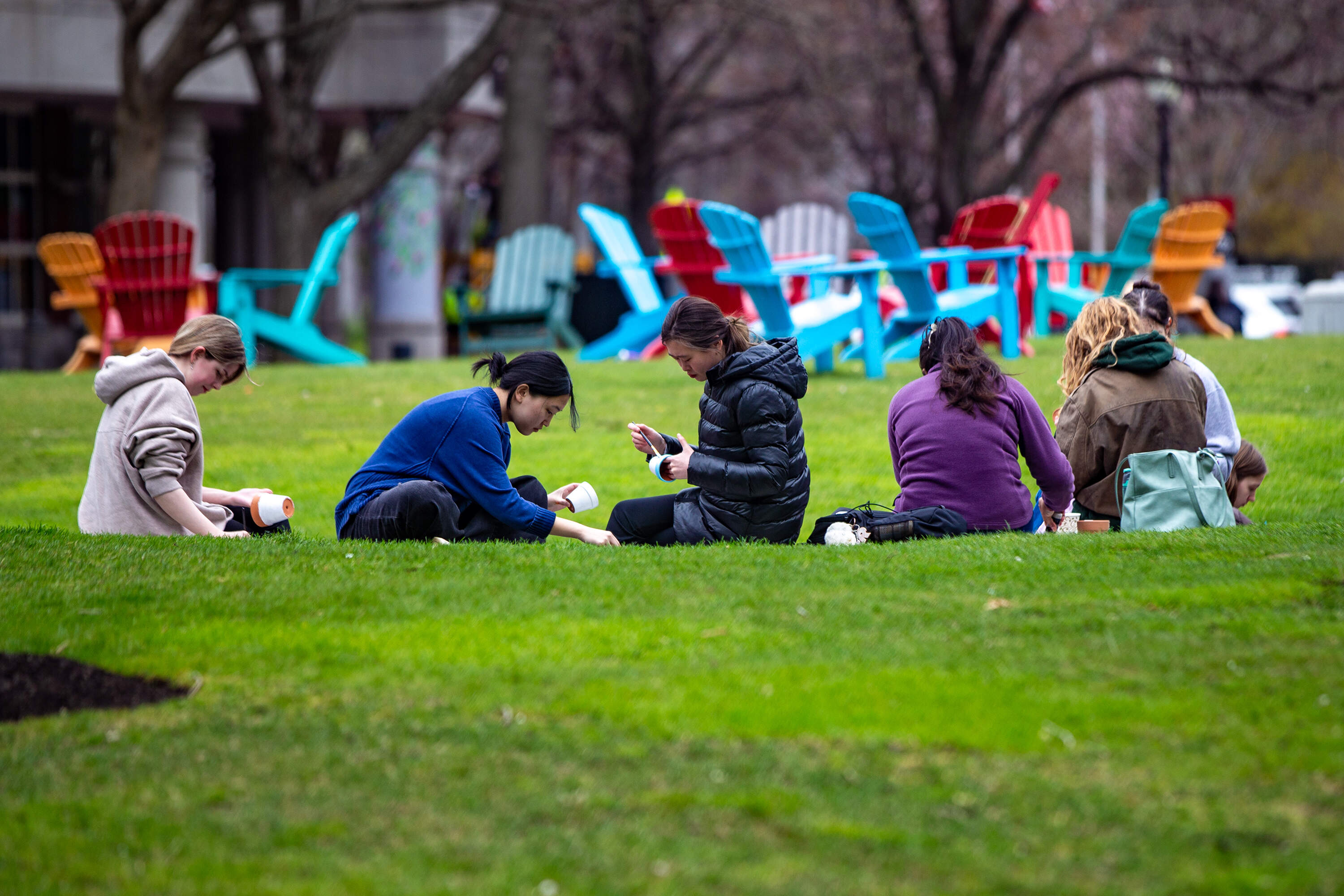 Students paint planters on Centennial Common at Northeastern University. (Jesse Costa/WBUR)