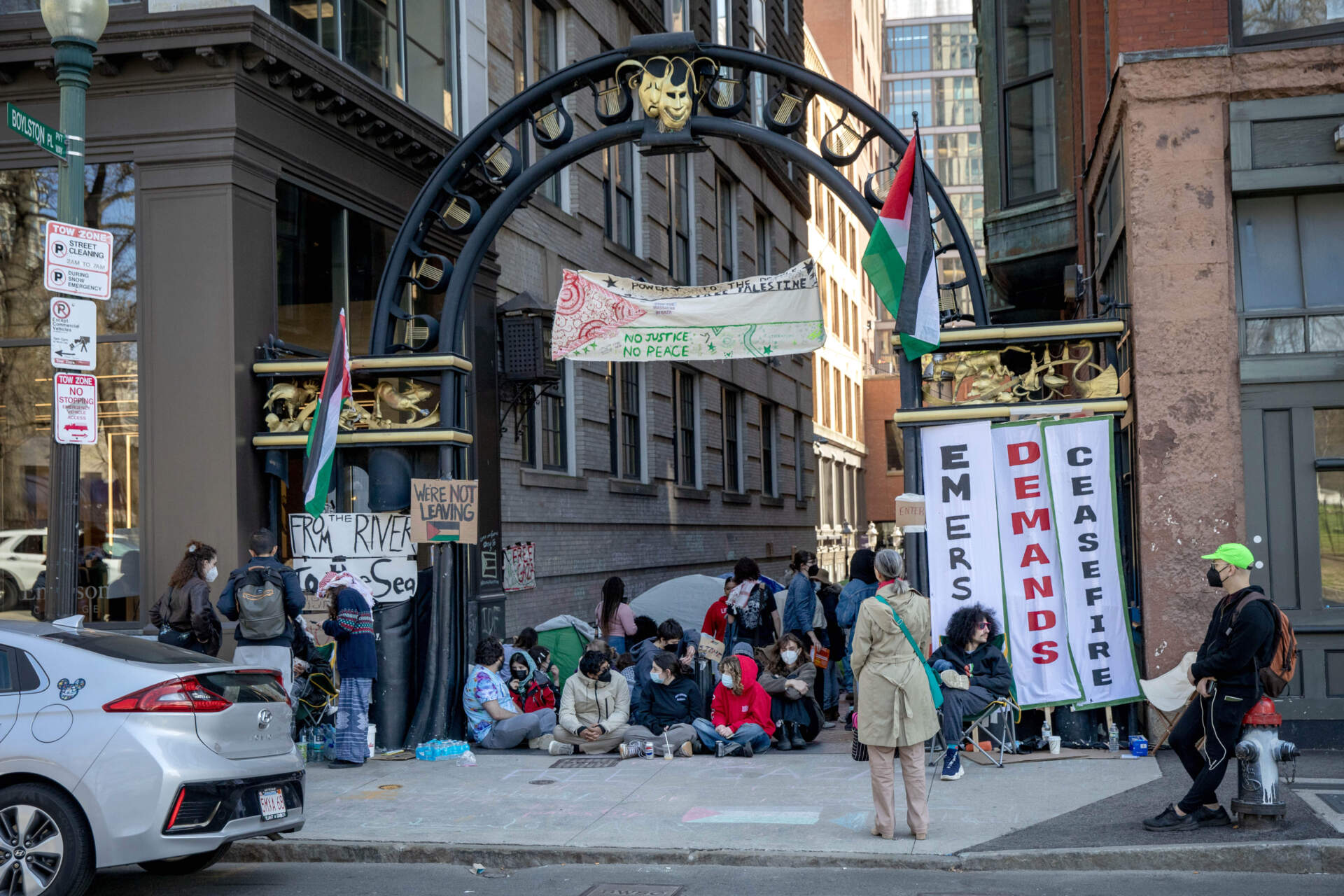 Emerson students demanding a ceasefire in Gaza sit across the entrance to Boylston Place. (Robin Lubbock/WBUR)