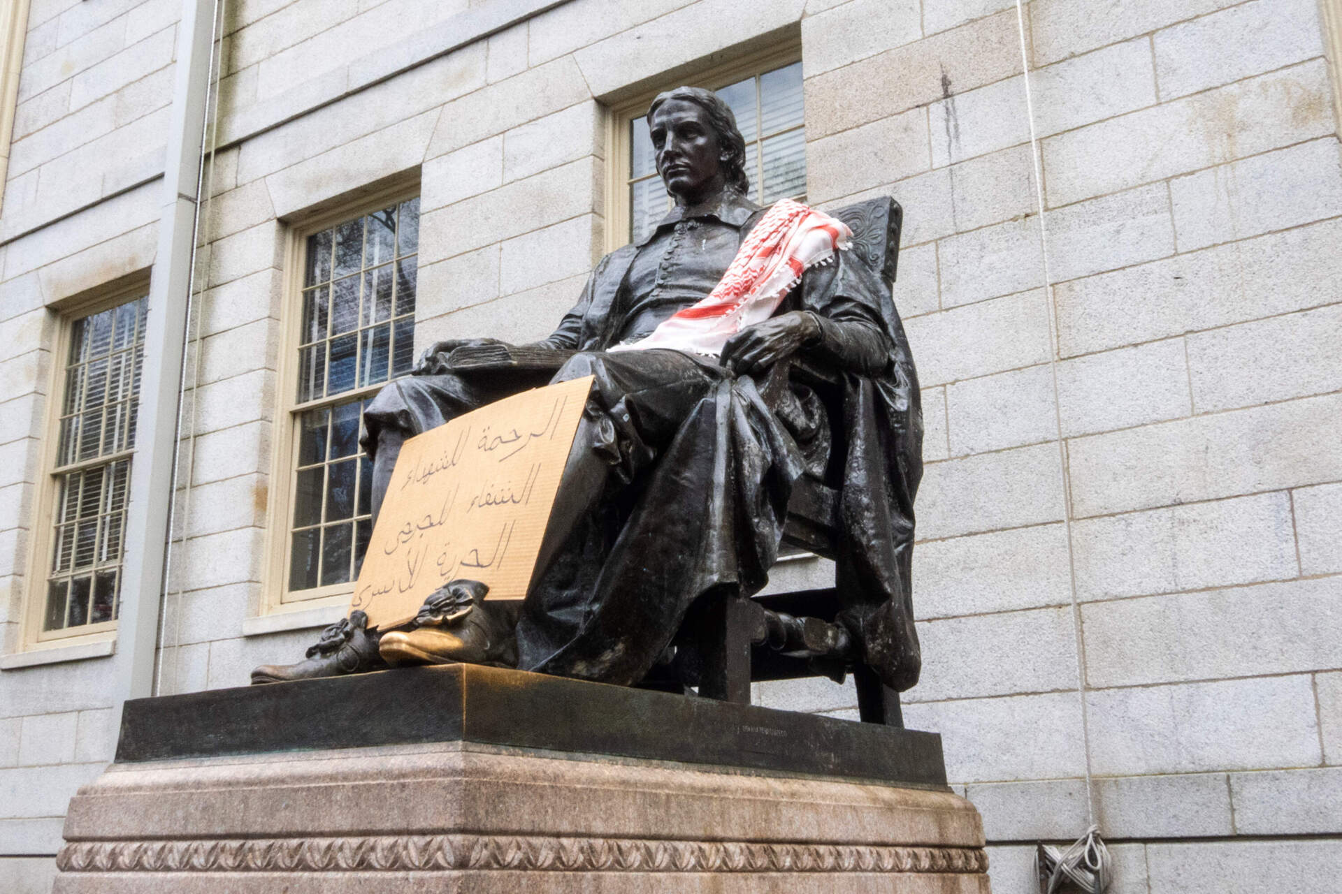 The John Harvard statue on Harvard Yard in Cambridge. (Max Larkin/WBUR)