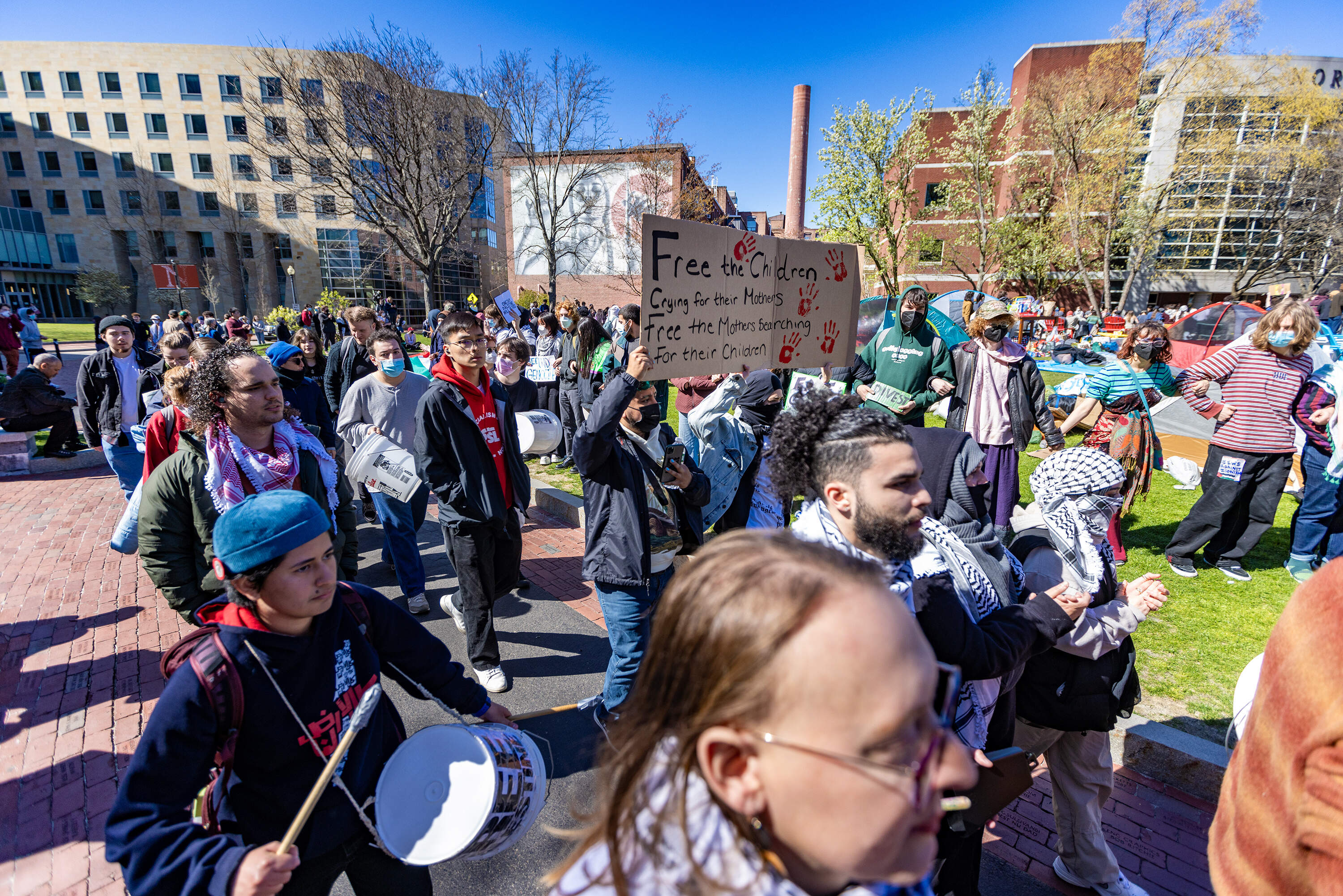 Protesters march around the tent encampment after police withdraw from the scene at Centennial Common at Northeastern University Thursday afternoon. (Jesse Costa/WBUR)