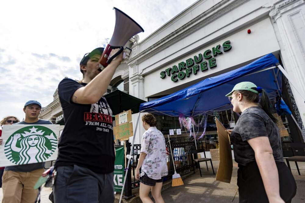 Striking workers at Starbucks march out in front of the location on Commonwealth Avenue in Boston. (Jesse Costa/WBUR