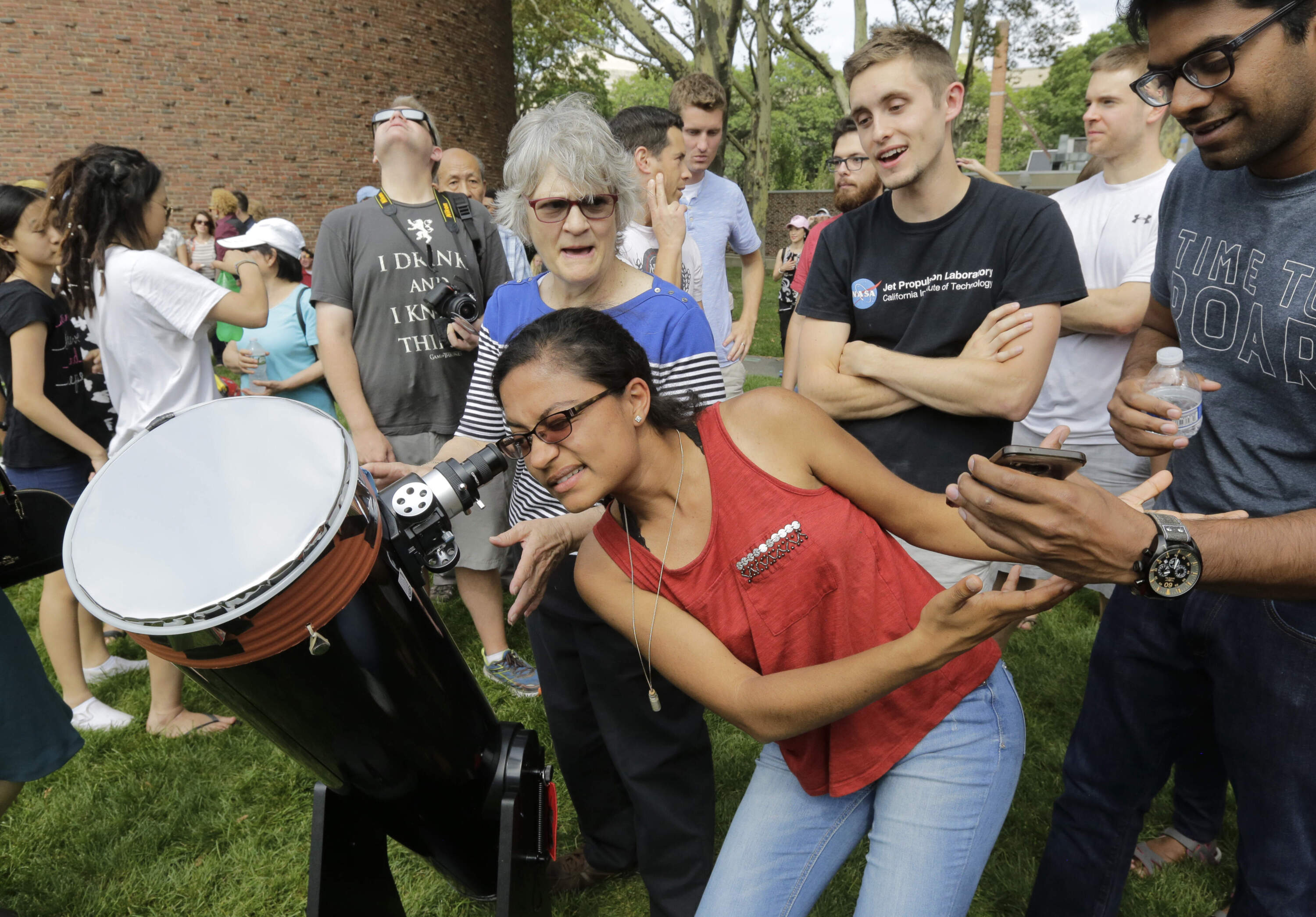 Massachusetts Institute of Technology student Niyati Desai, of Cambridge, looks through a telescope to view a partial solar eclipse on Aug. 21, 2017, on the MIT campus. (Steven Senne/AP)