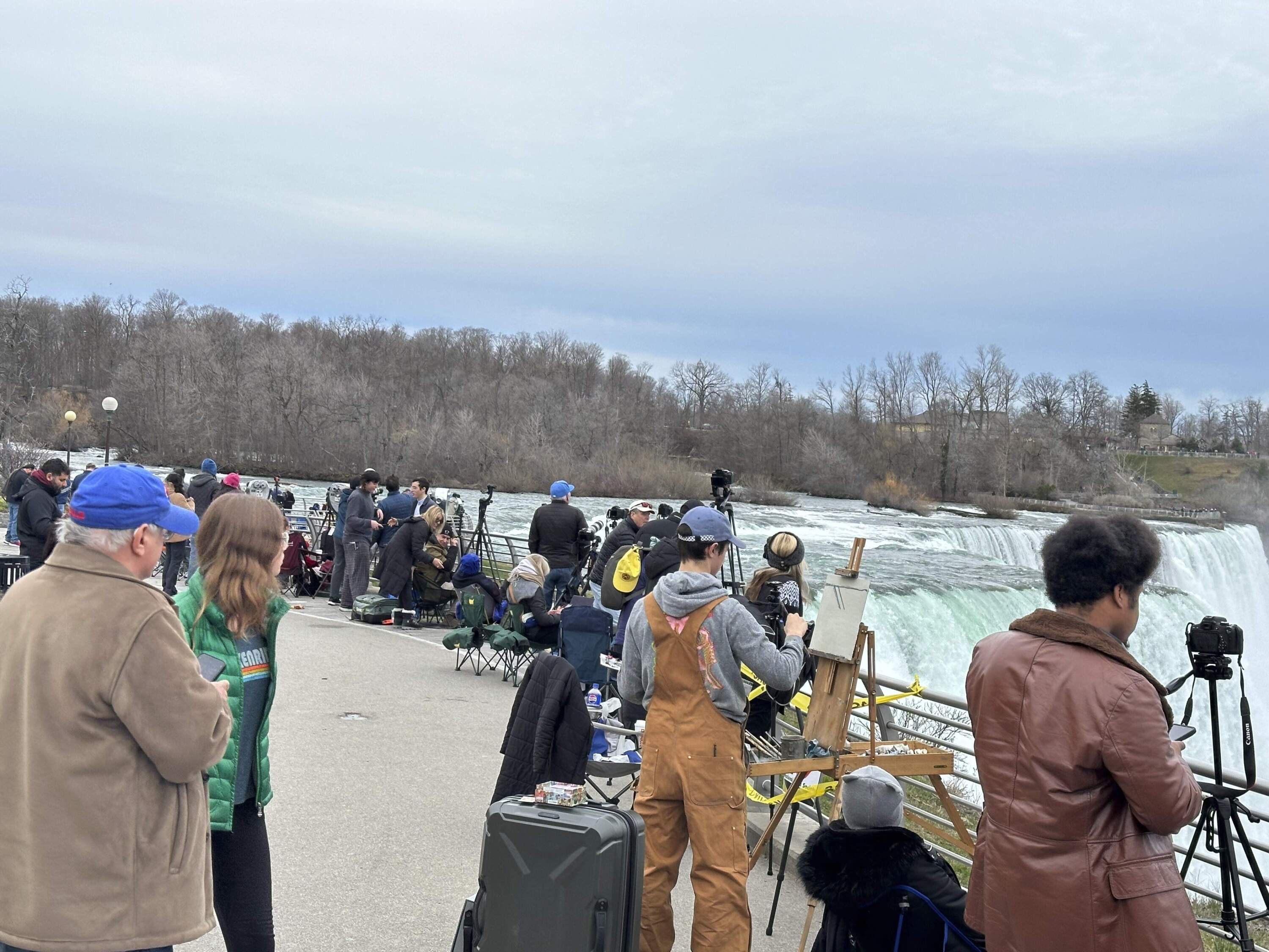Groups of tourists streamed into Niagara Falls State Park to view the solar eclipse.. (Carolyn Thompson/AP)